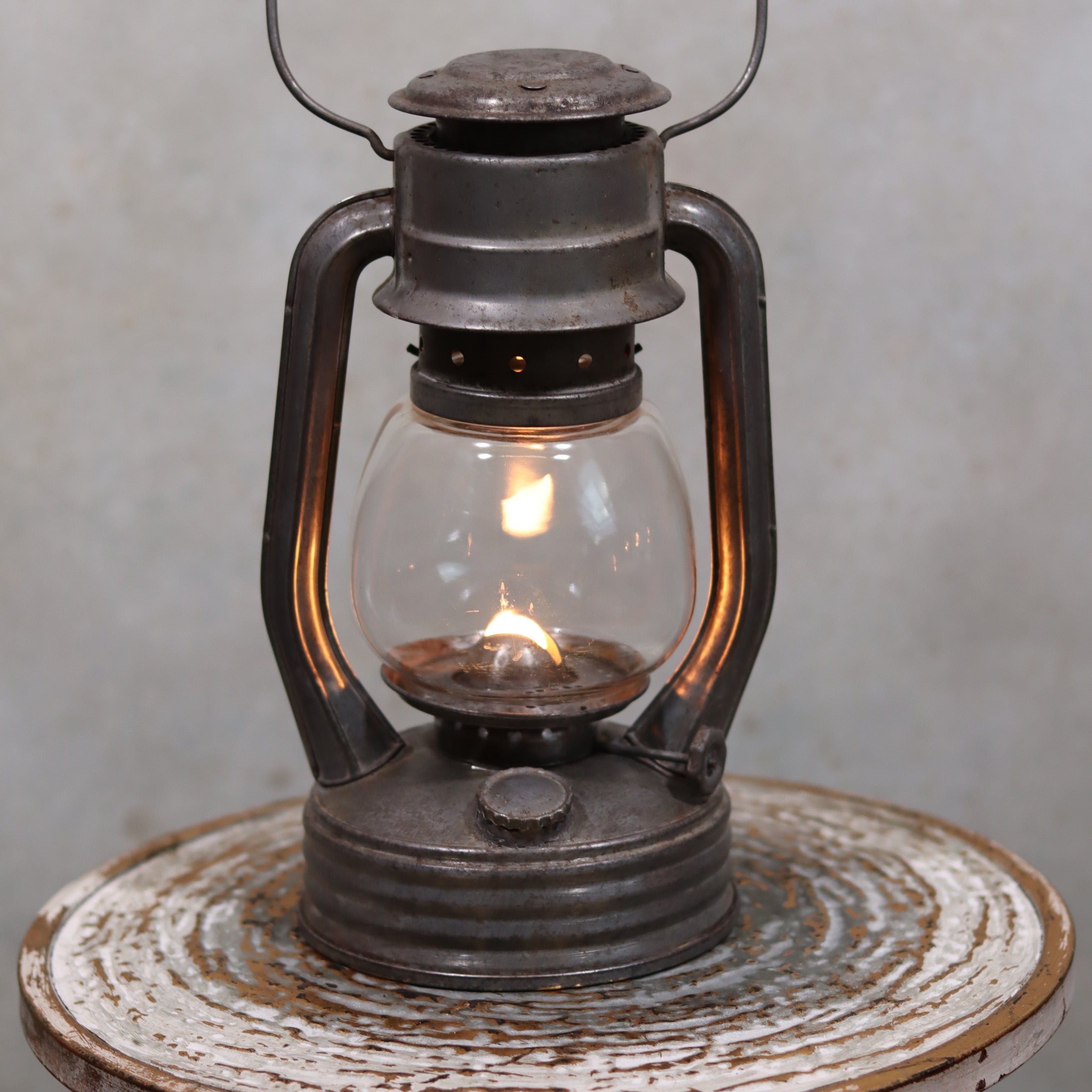 Vintage French Royalux Hurricane Lantern – Glass Lift Mechanism (27 cm) showing classic oil lamp design with lit flame