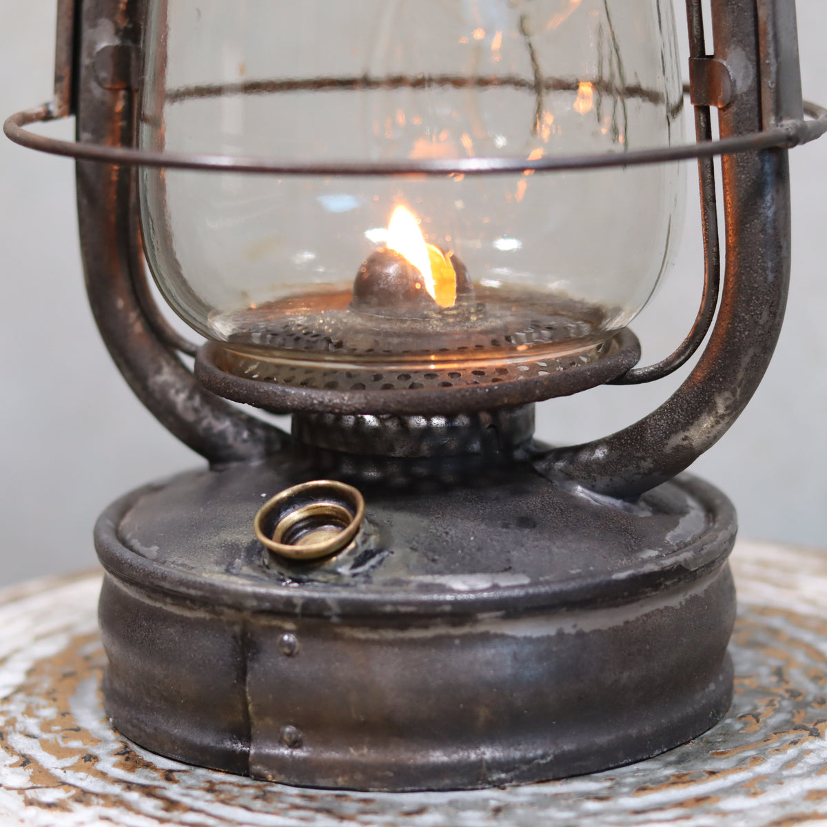 Rare Antique Hurricane Lantern – Stübgen & Co, DR Patent 2833 (Circa 1907–1909) oil lamp with lit flame and weathered metal base