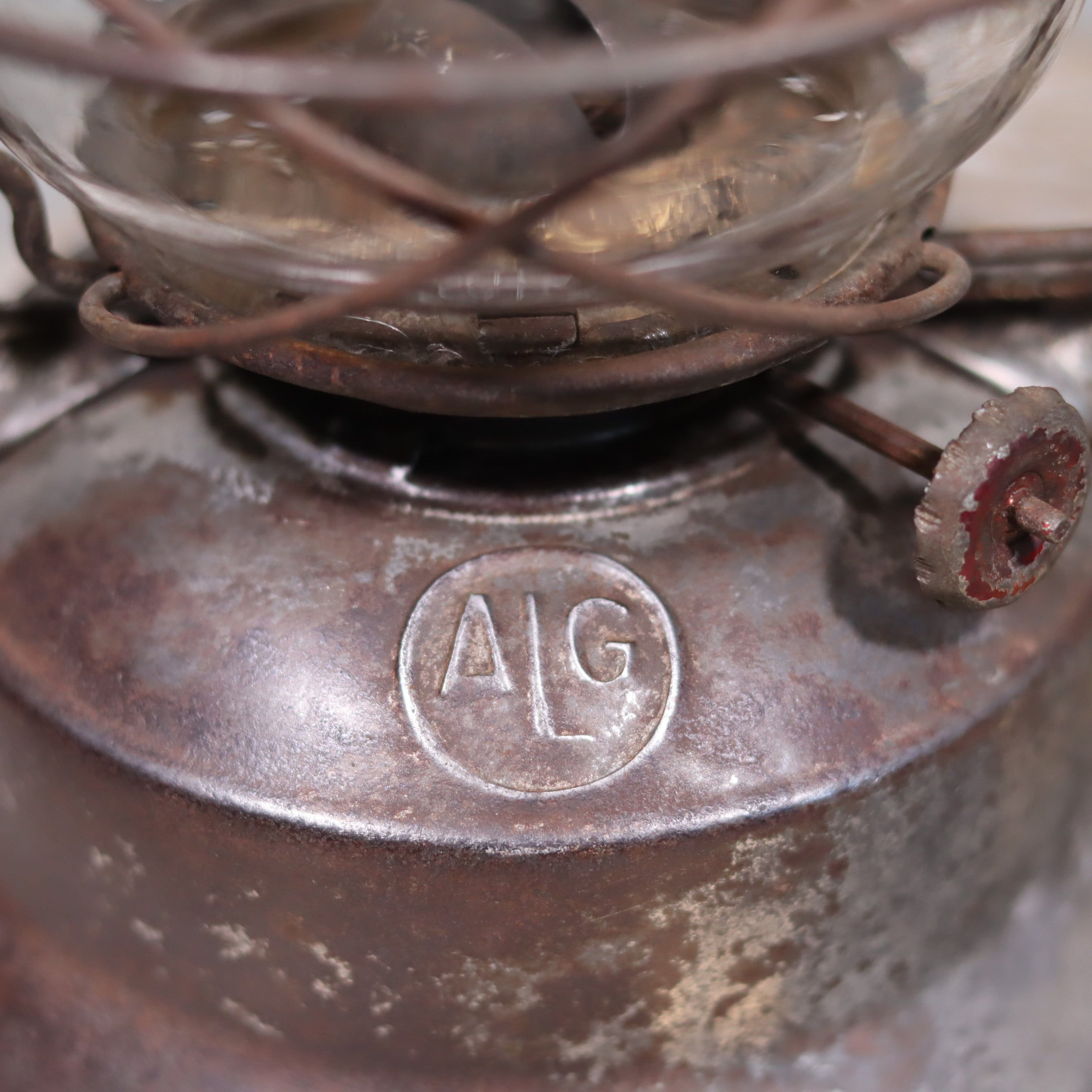Close-up of the Vintage French ALG Guillouard Hurricane Lantern – Luciole Model (1960s–1980s) oil lamp brand mark on metal surface