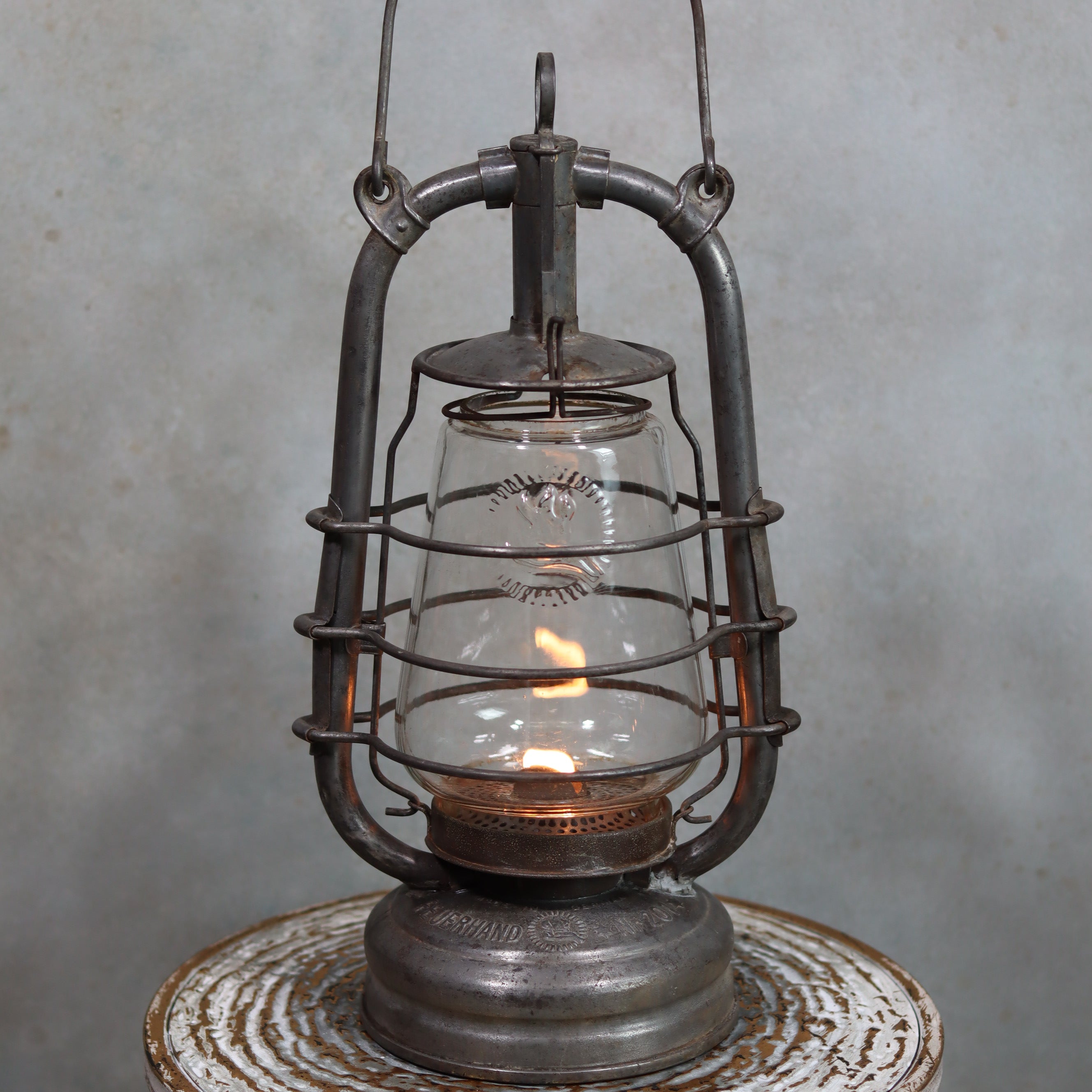 Vintage Feuerhand 201 Storm Lantern – Rare Glass, 1920s–1930s, Well-Worn Patina oil lamp with visible flame and metal frame