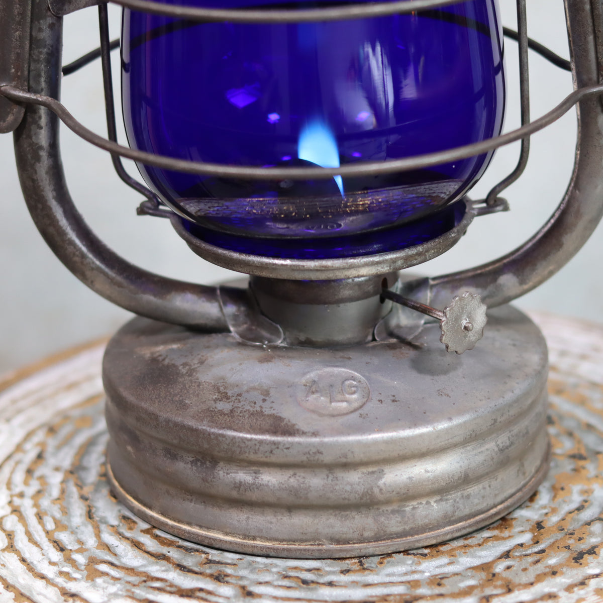 Rare Vintage ALG No. 2 French Hurricane Lantern – 1960s/70s – Blue Glass & Unique Handle close-up of oil lamp flame and metal base