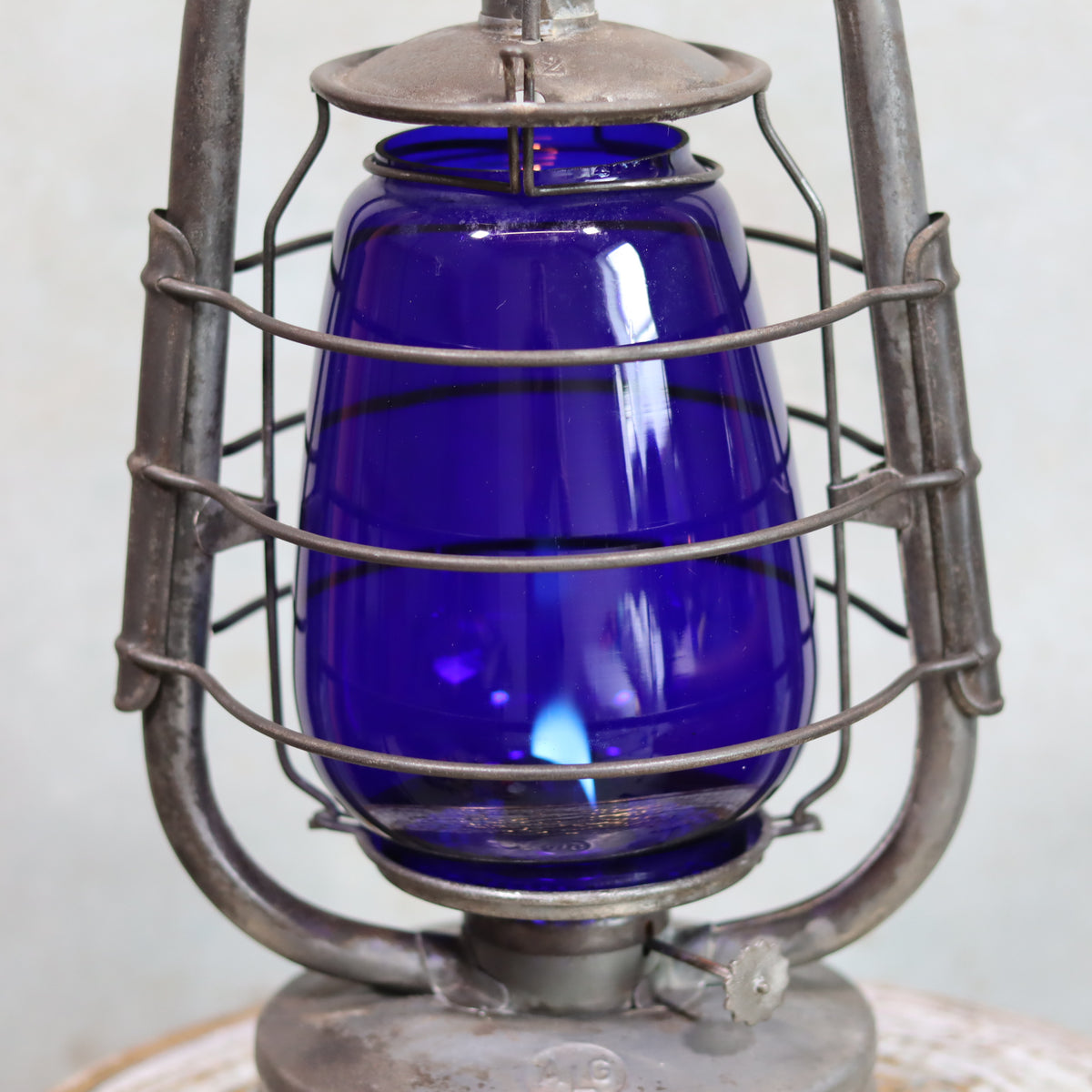 Rare Vintage ALG No. 2 French Hurricane Lantern – 1960s/70s blue glass oil lamp with unique handle design and metal frame.