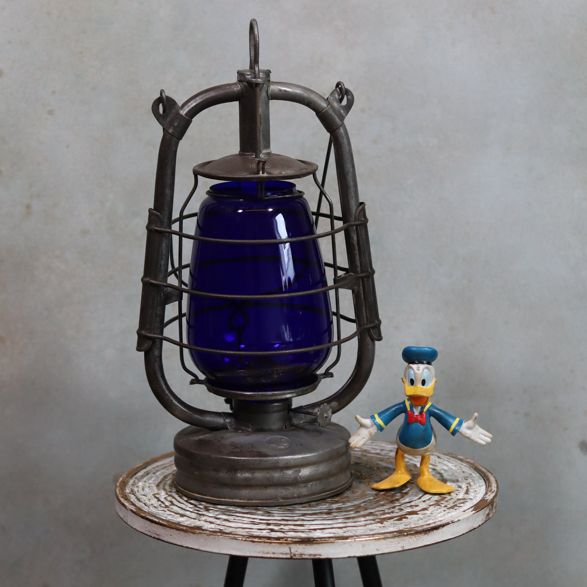 Rare Vintage ALG No. 2 French Hurricane Lantern – 1960s/70s – Blue Glass & Unique Handle oil lamp displayed on rustic table