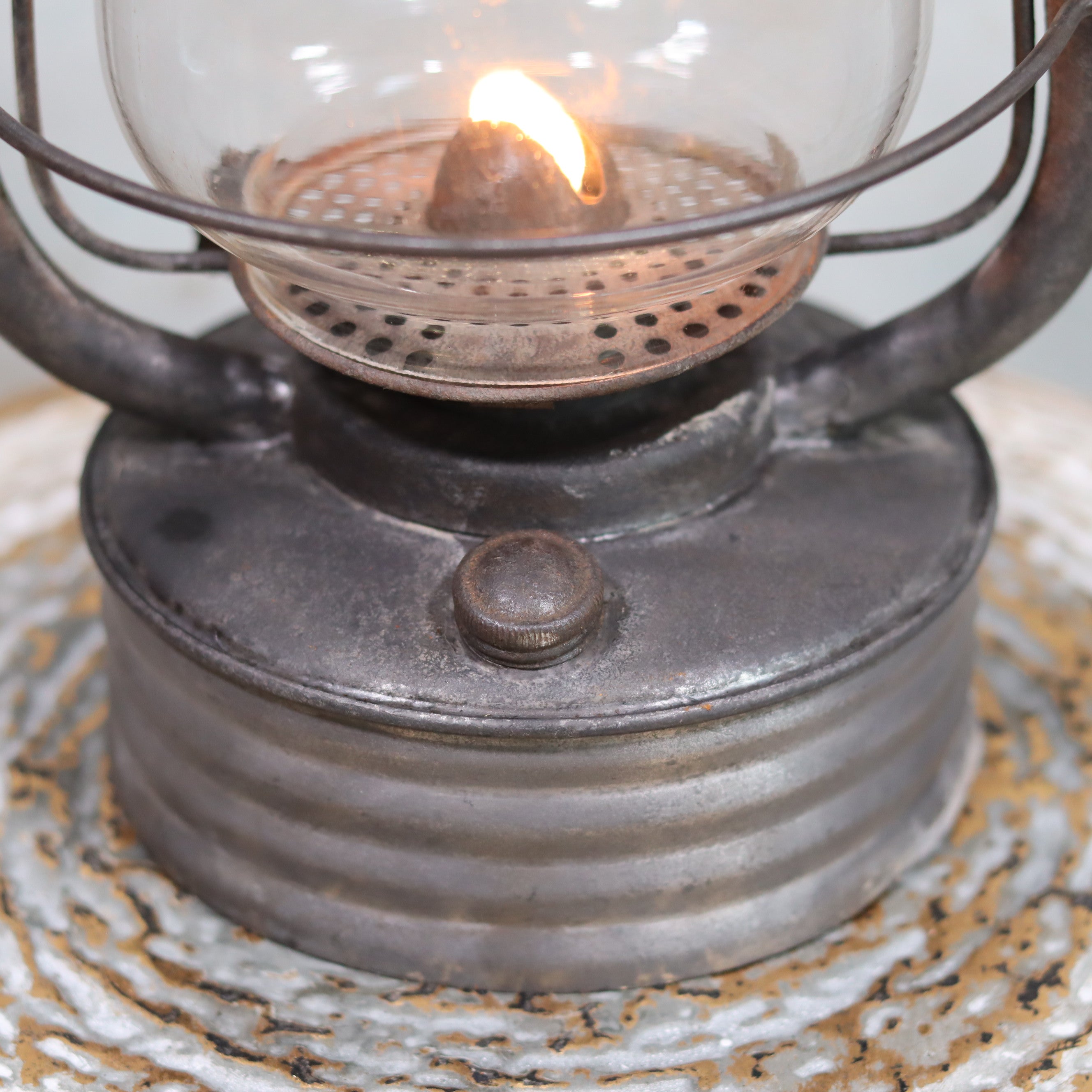 Close-up of lit oil lamp on Vintage French Hurricane Lantern – SIF 500 – Cristal Supérieur Glass – 1950s–1970s showing detailed metal base and flame.
