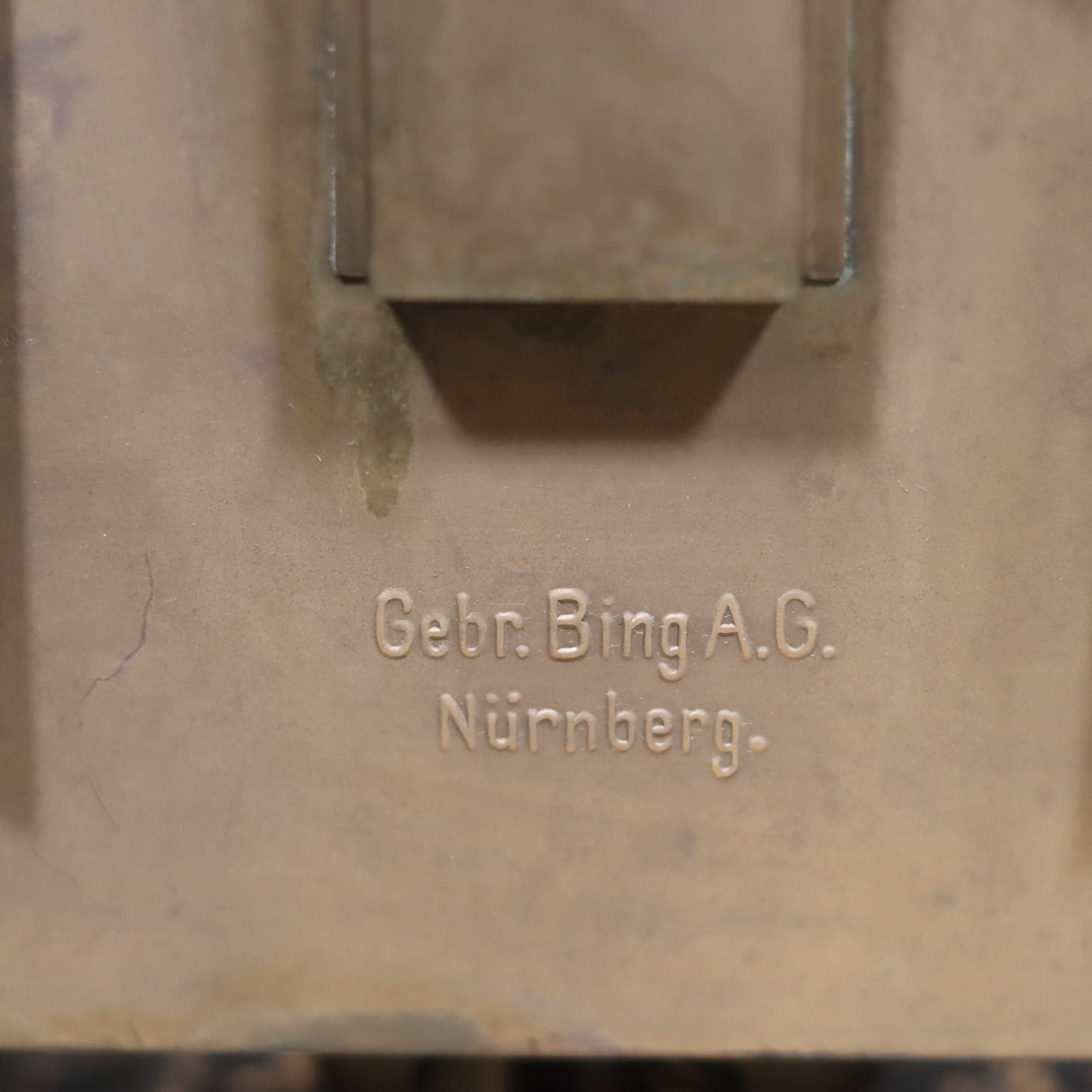 Close-up of the Rare Antique Trench Lamp & Candle Holder – Gebr. Bing A.G. Nürnberg (1920s–1940s) brand engraving.