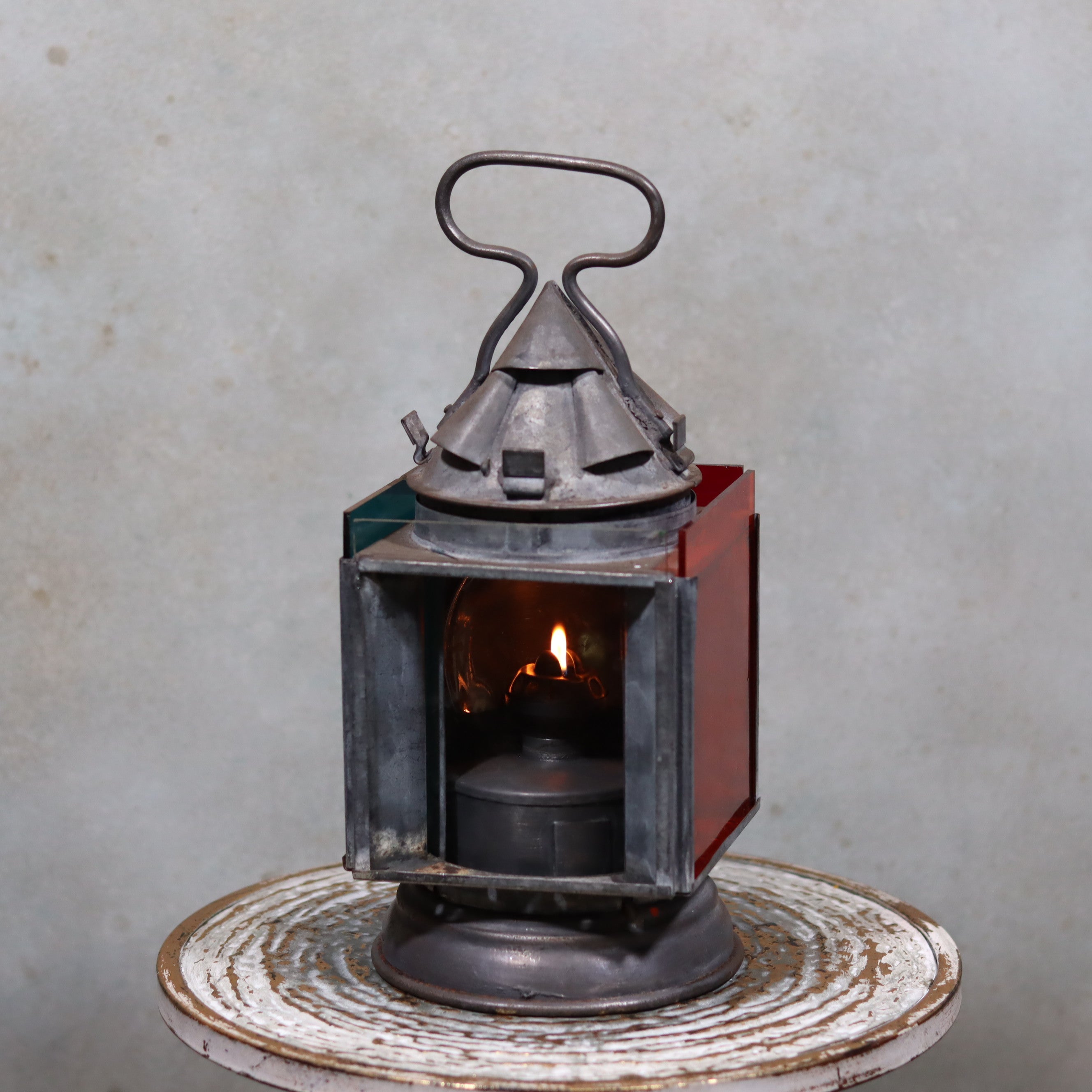 Vintage Railway Signal Lantern – Rare Collectible with 4 Colored Glass Panels featuring a lit oil lamp in antique metal casing