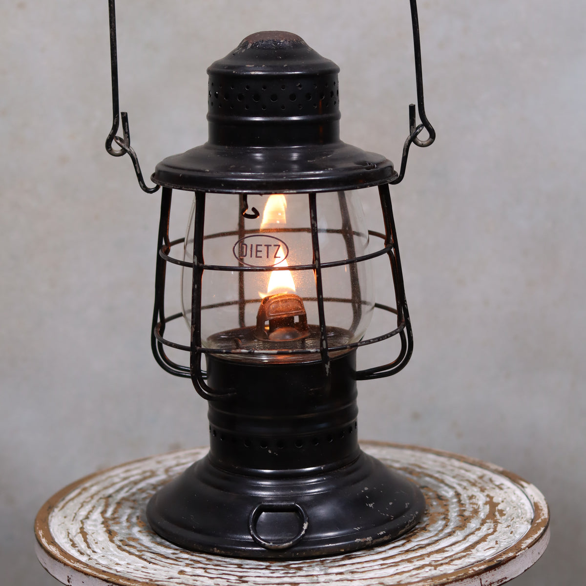 Vintage Keystone Ware Hurricane Lantern – Black Finish with Dietz Glass oil lamp lit on rustic surface showcasing vintage design and brand detail