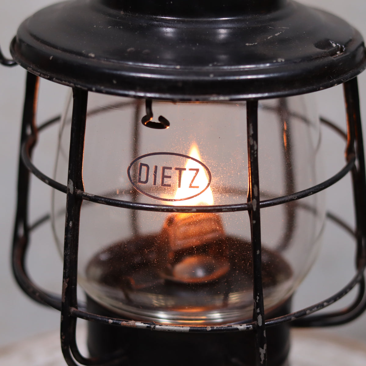 Vintage Keystone Ware Hurricane Lantern – Black Finish with Dietz Glass oil lamp showing lit flame and protective metal cage