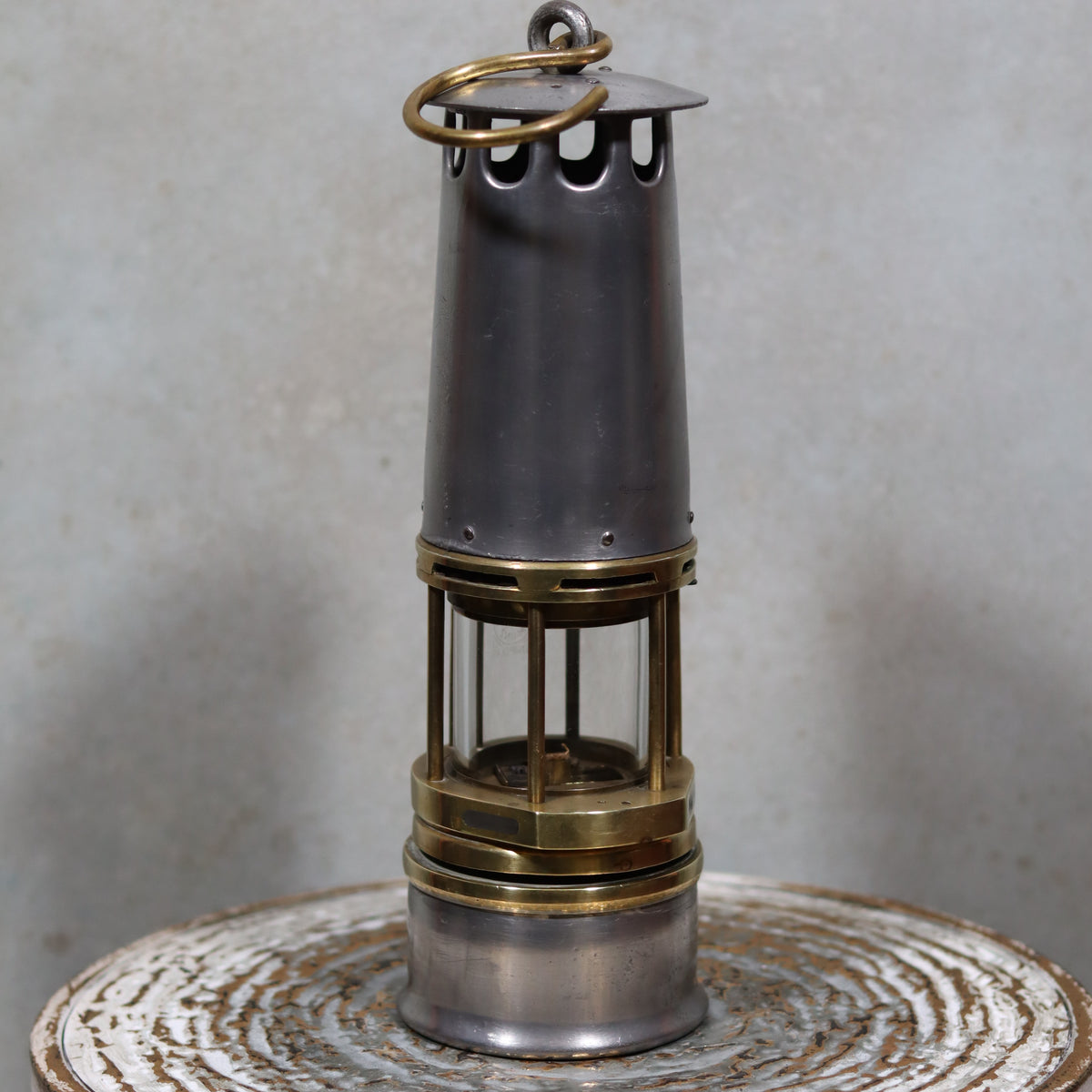 Rare New Old Stock Mining Lamp – Hubert Joris (Circa 1900–1910) oil lamp with brass and metal details on rustic surface