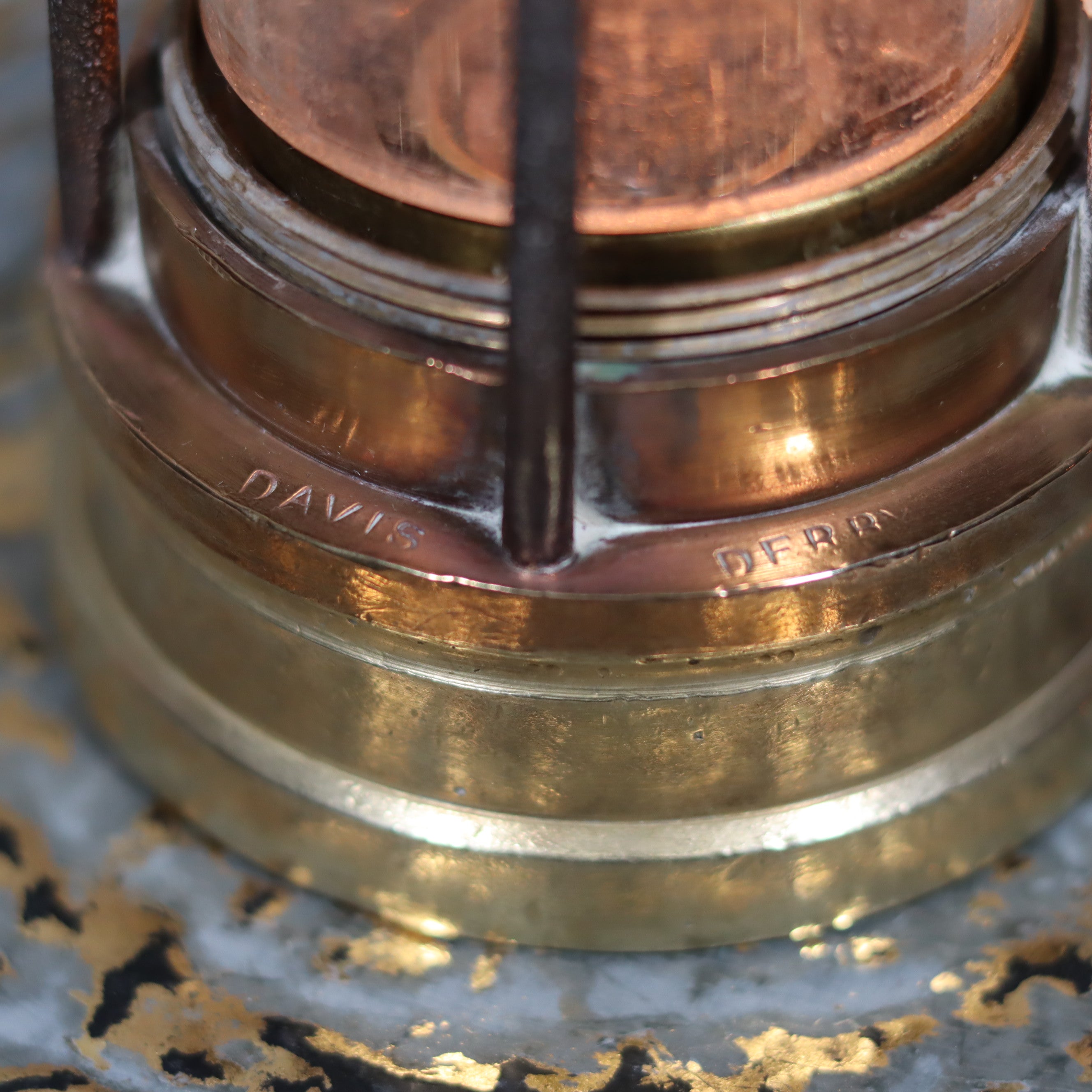 Close-up of the brass base marked Davies Derby on the Antique British Mining Lamp – Davies Derby Safety Lamp (Circa 1900)