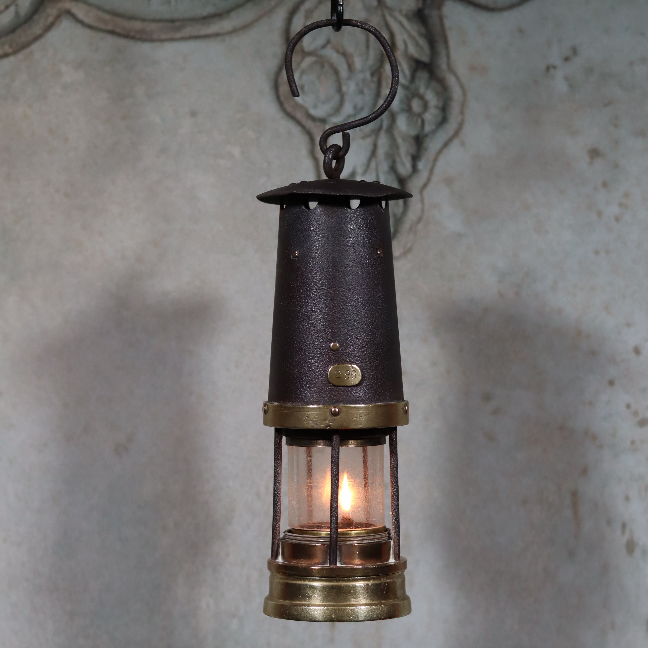 Antique British Mining Lamp – Davies Derby Safety Lamp (Circa 1900) with lit oil lamp and brass accents hanging on hook