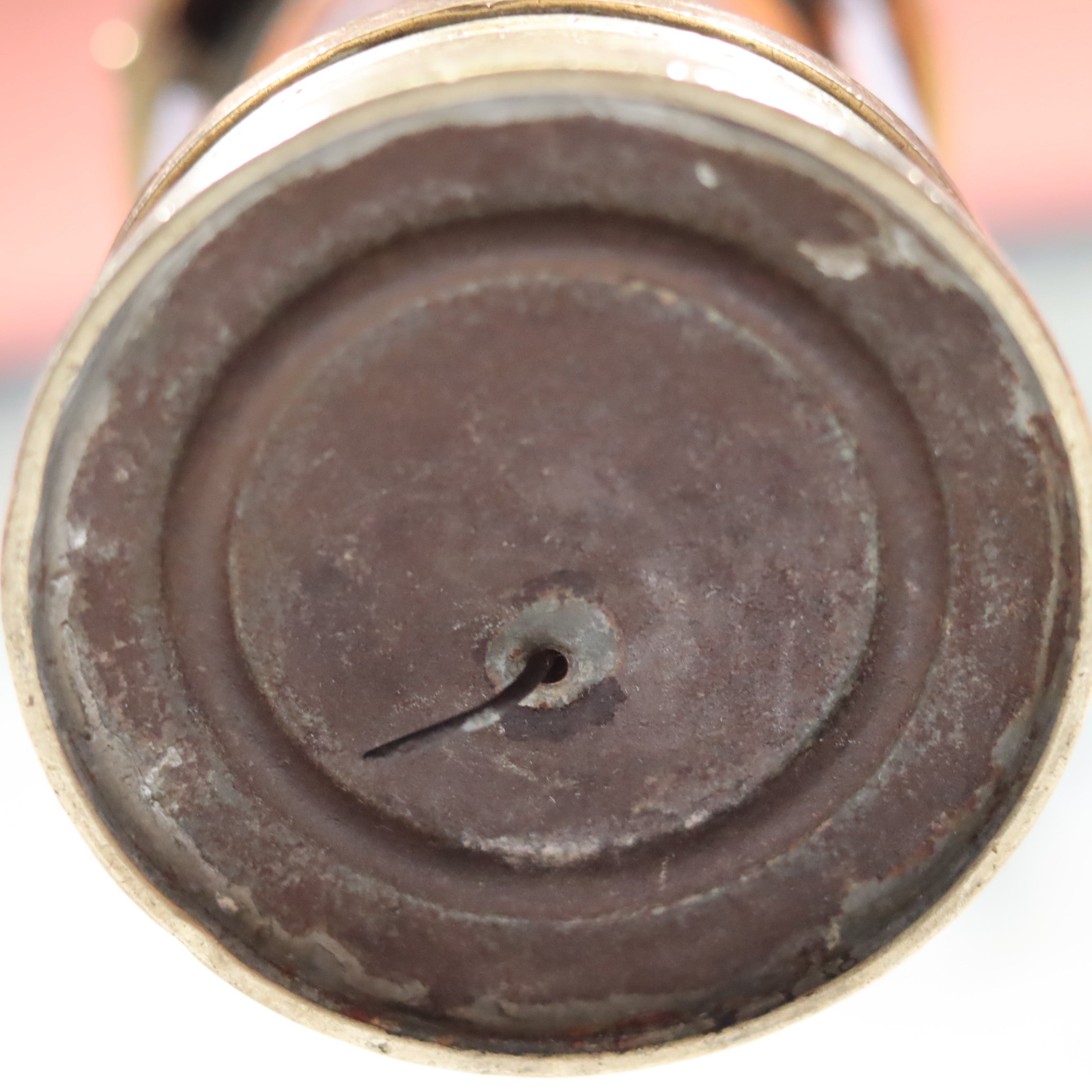 Bottom view of the Antique British Mining Lamp – Davies Derby Safety Lamp (Circa 1900) showing aged metal base.