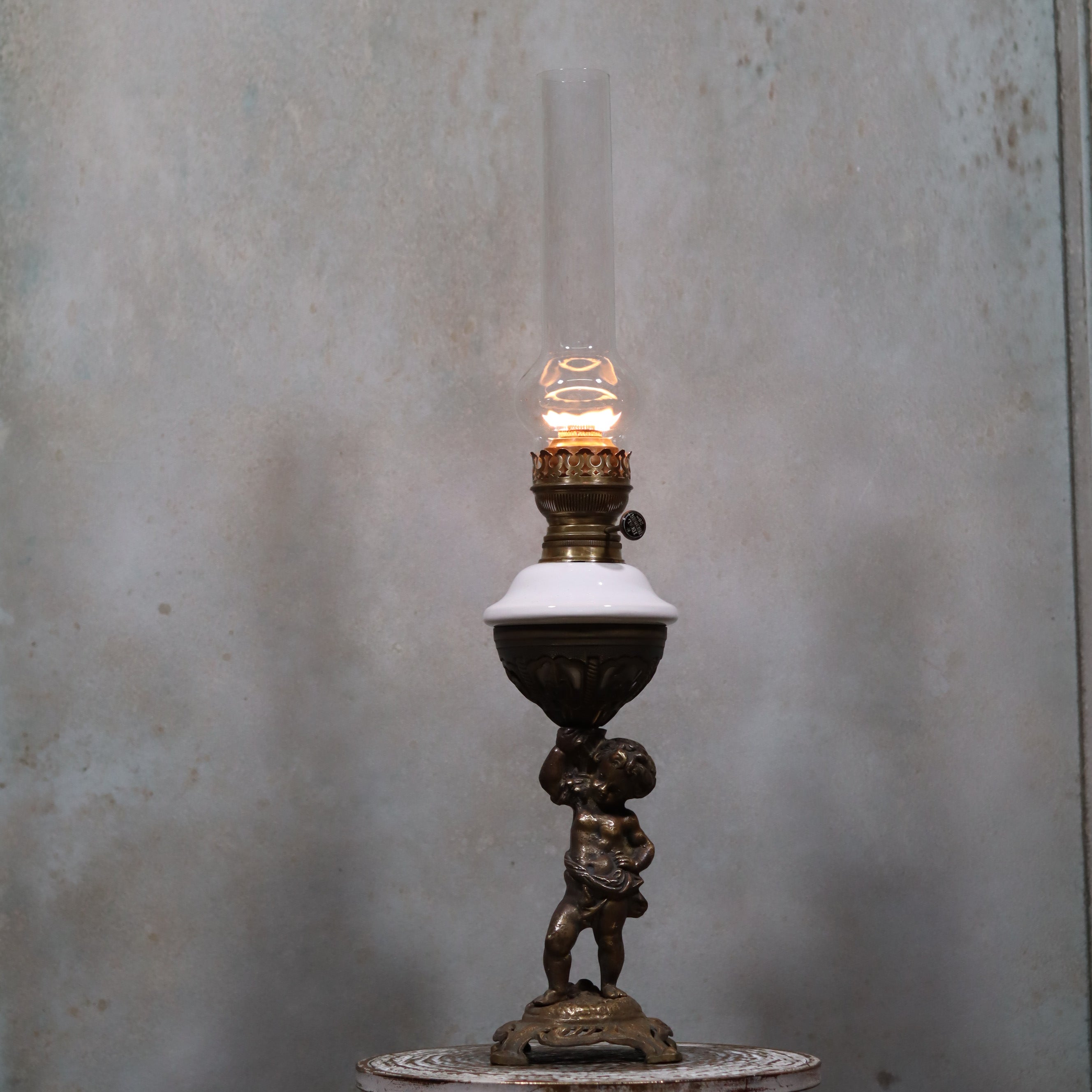 Vintage XXL Oil Lamp with BJB Matador Burner – Bronze Base with Cherub Design lit against a neutral background