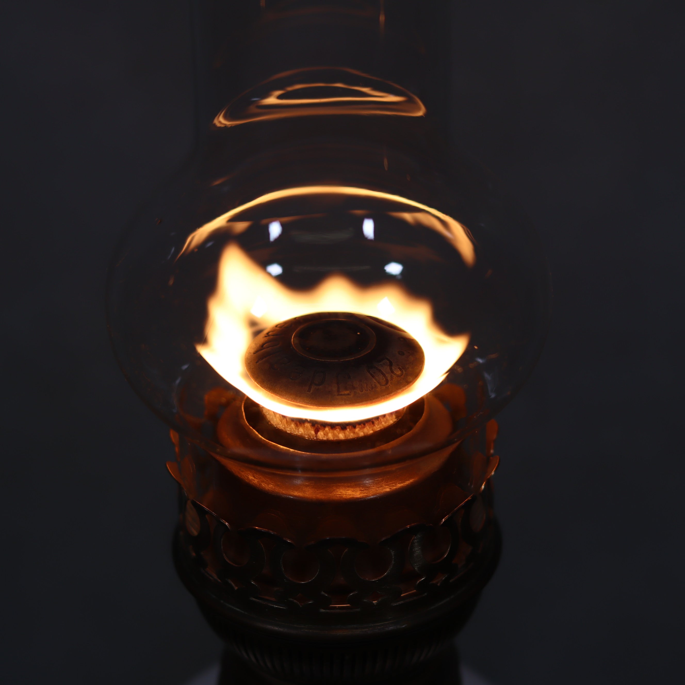 Vintage XXL Oil Lamp with BJB Matador Burner – Bronze Base with Cherub Design lit flame close-up in dark background