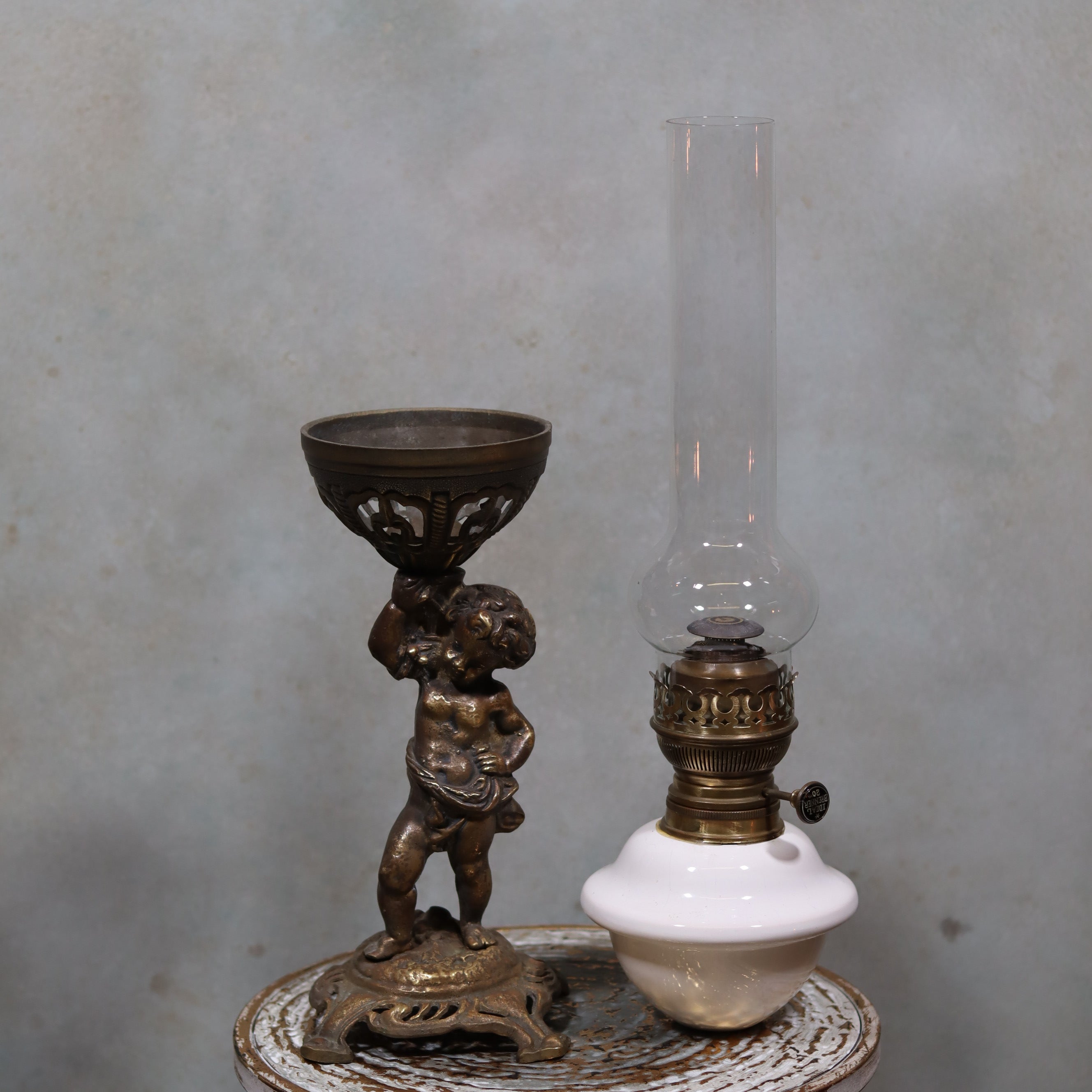 Vintage XXL Oil Lamp with BJB Matador Burner – Bronze Base with Cherub Design shown on rustic table background