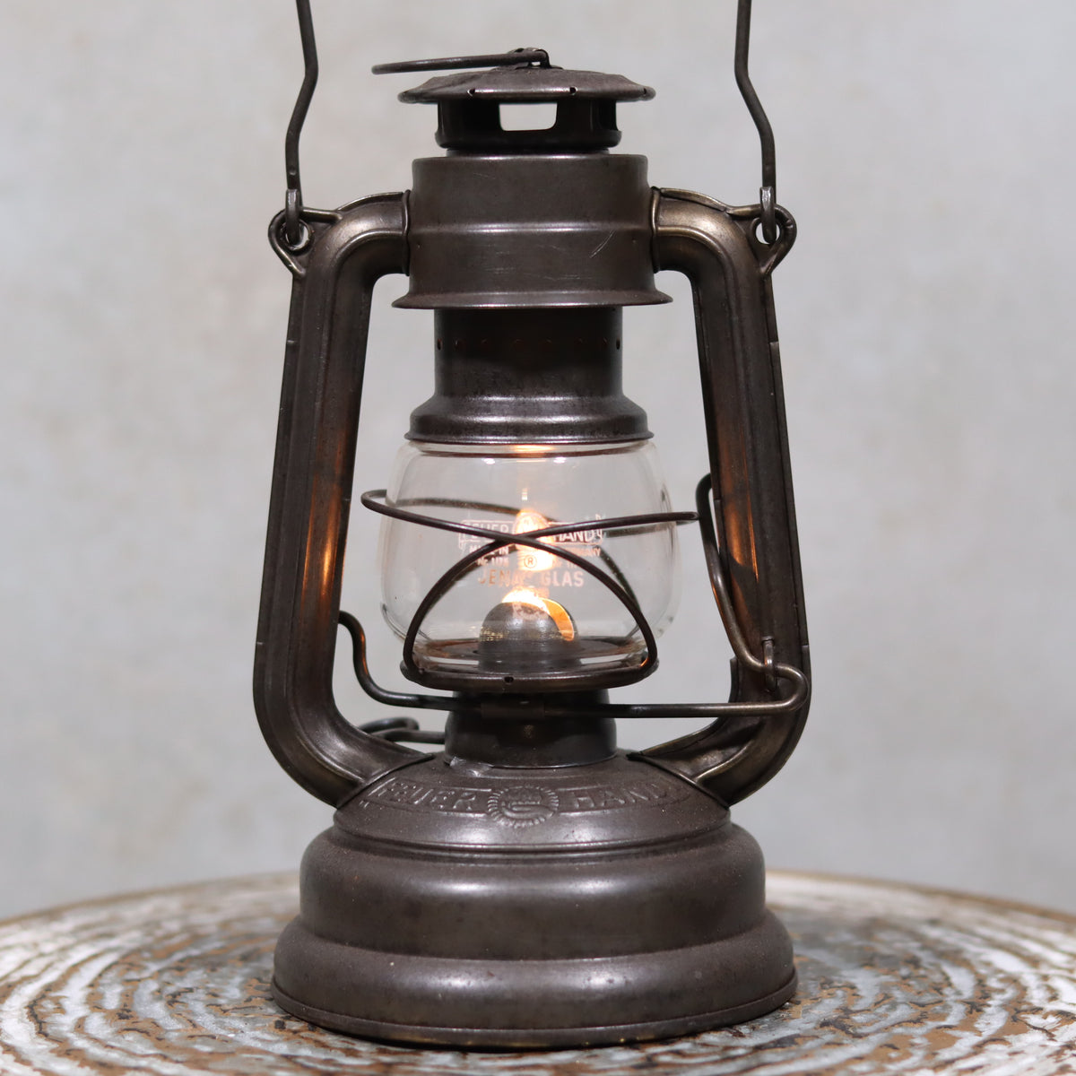 Vintage Feuerhand 176 Storm Lantern – Post-WWII Model, 1950s, Excellent Condition oil lamp glowing with metal frame and glass chimney