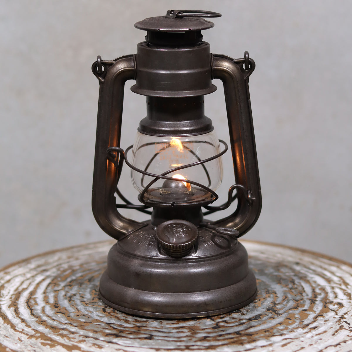 Vintage Feuerhand 176 Storm Lantern – Post-WWII Model, 1950s, Excellent Condition oil lamp with a burning flame in metal frame.