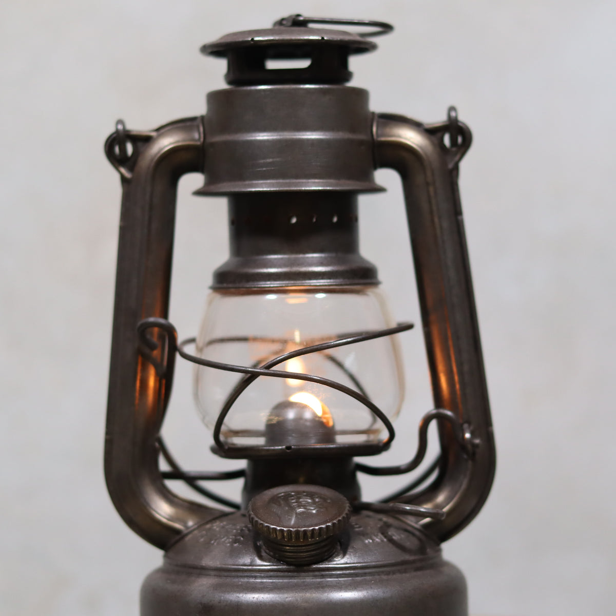 Vintage Feuerhand 176 Storm Lantern – Post-WWII Model, 1950s, Excellent Condition oil lamp glowing softly in close-up view