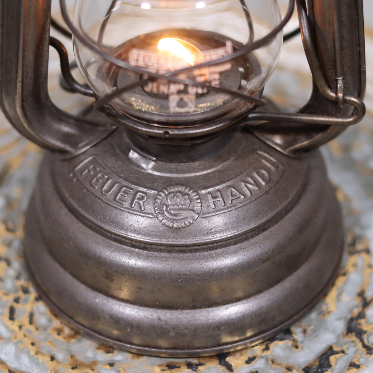 Close-up of Vintage Feuerhand 176 Storm Lantern – Post-WWII Model, 1950s, Excellent Condition oil lamp base and flame detail.