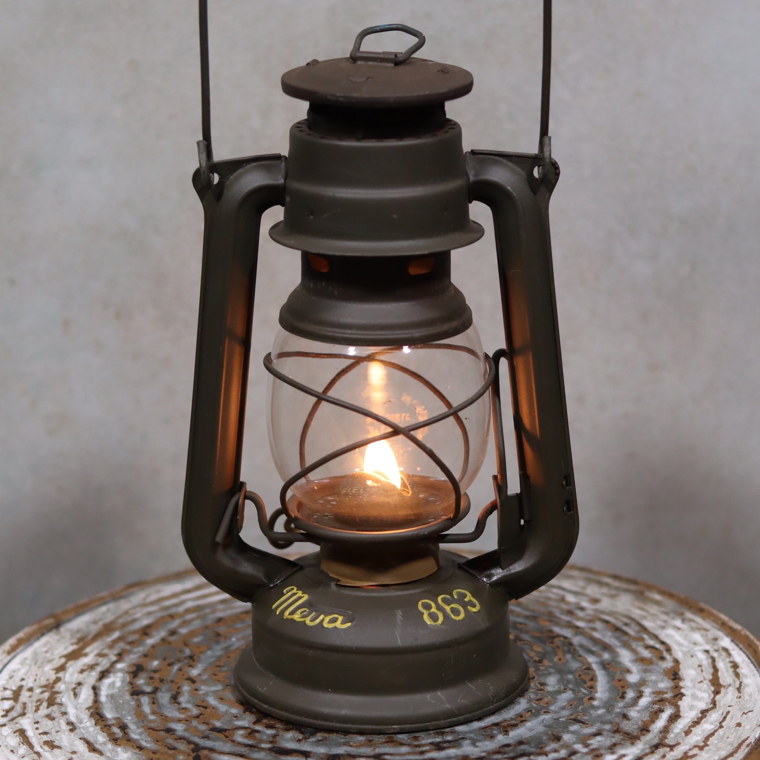 Vintage Czech Storm Lantern – Meva 863 – Made in Czechoslovakia – 1982 – Beautiful Painted Finish oil lamp lit on rustic surface