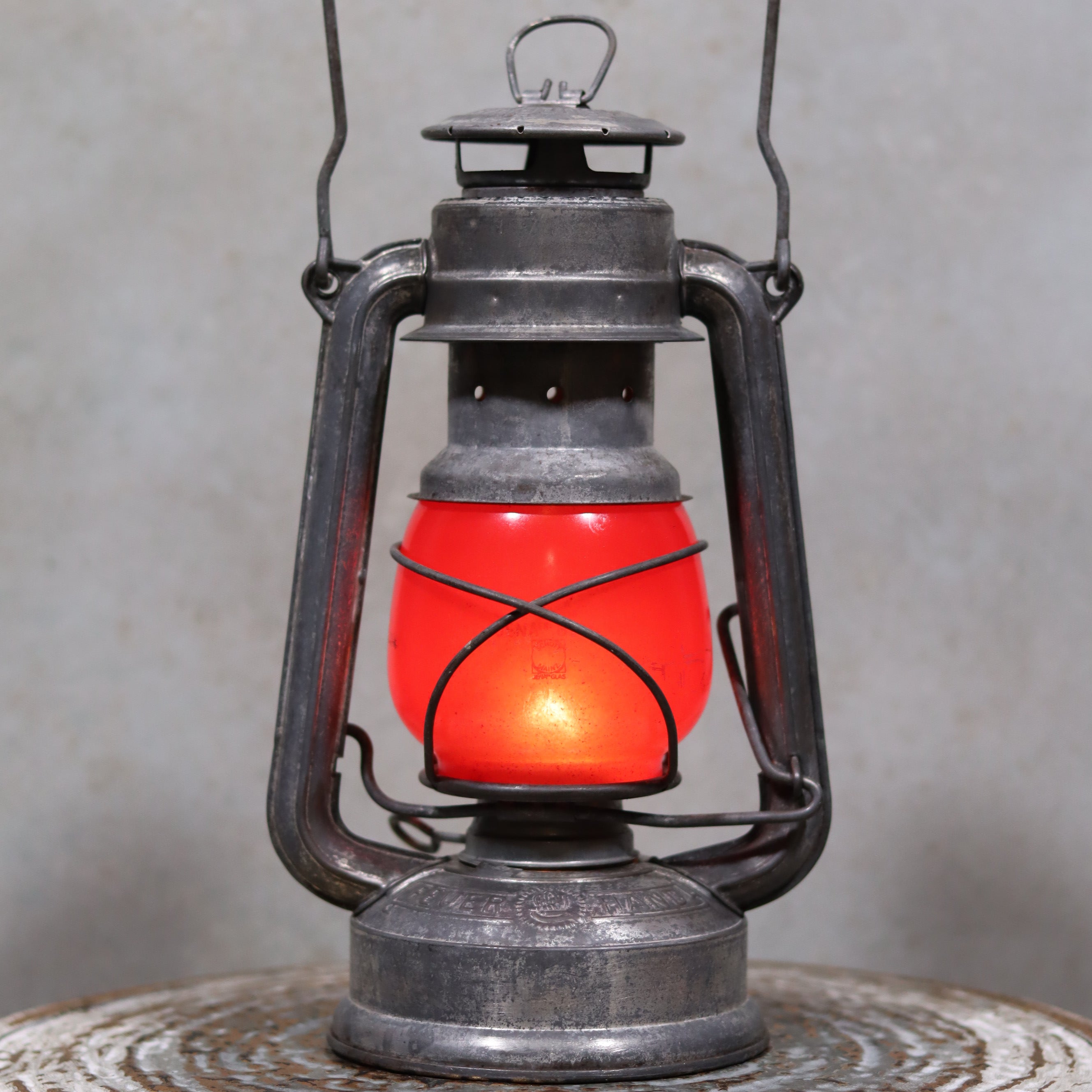 Vintage Feuerhand Baby 275 Hurricane Lantern – Western Germany – Red Glass oil lamp with rustic metal frame and glowing red glass shade