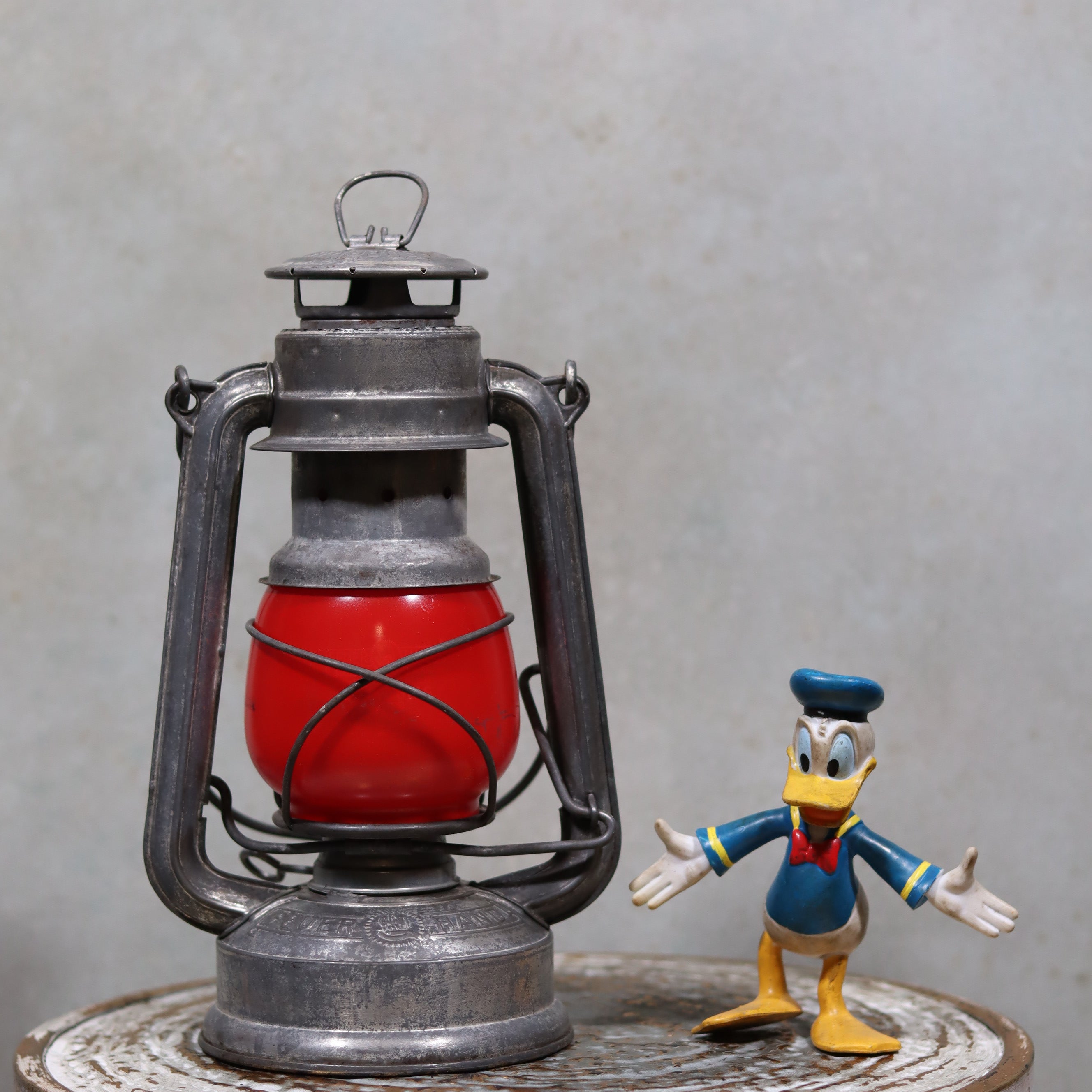 Vintage Feuerhand Baby 275 Hurricane Lantern – Western Germany – Red Glass oil lamp with classic metal frame and vibrant red glass globe.