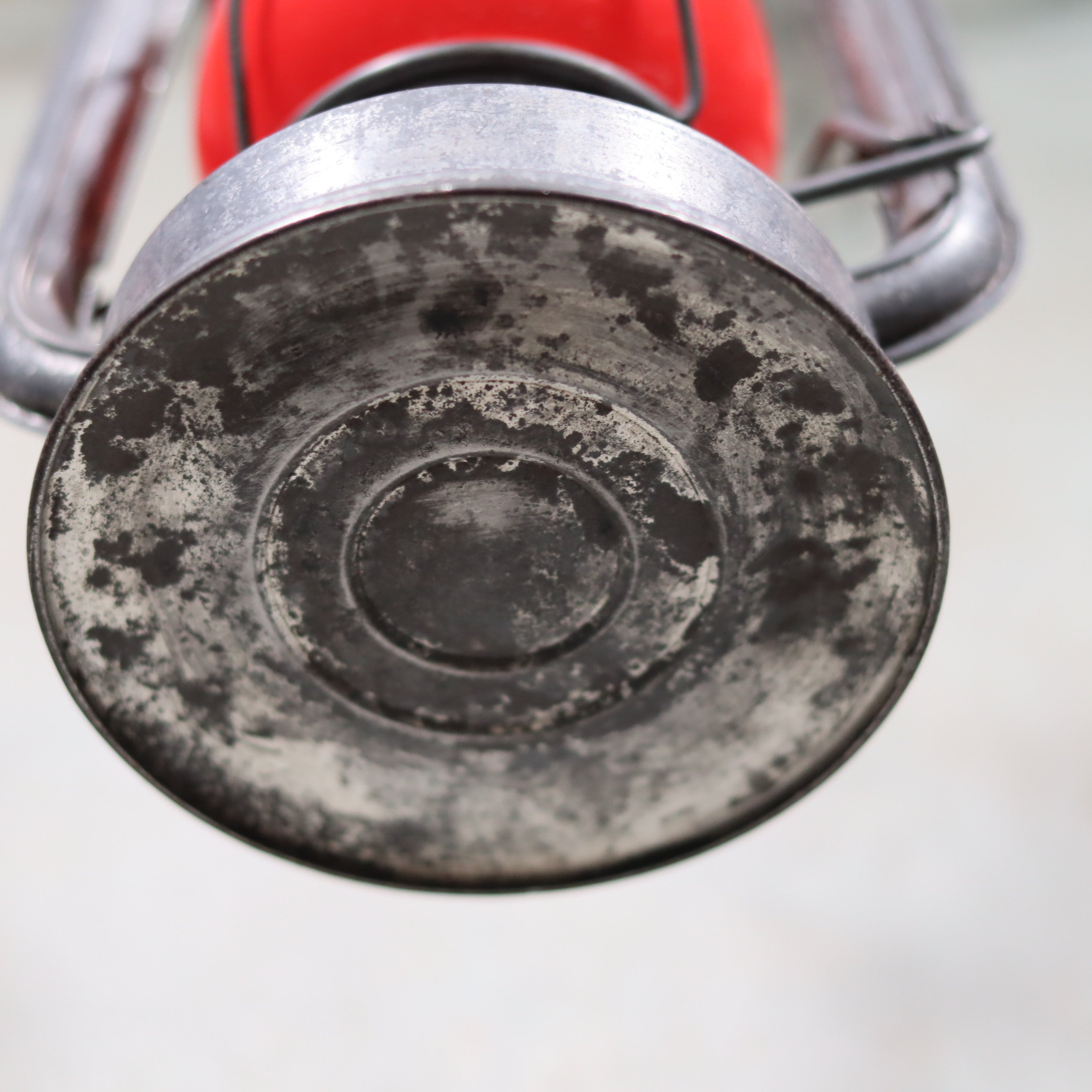 Close-up of the base of a Vintage Feuerhand Baby 275 Hurricane Lantern – Western Germany – Red Glass oil lamp.