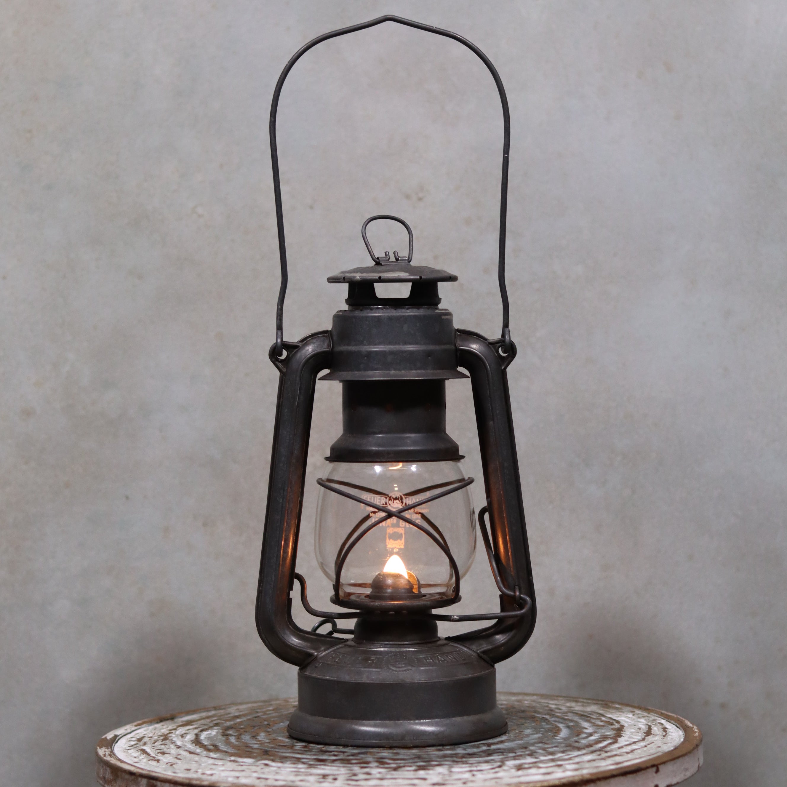 Vintage Feuerhand Baby 275 Hurricane Lantern – Western Germany oil lamp lit, showcasing classic German craftsmanship