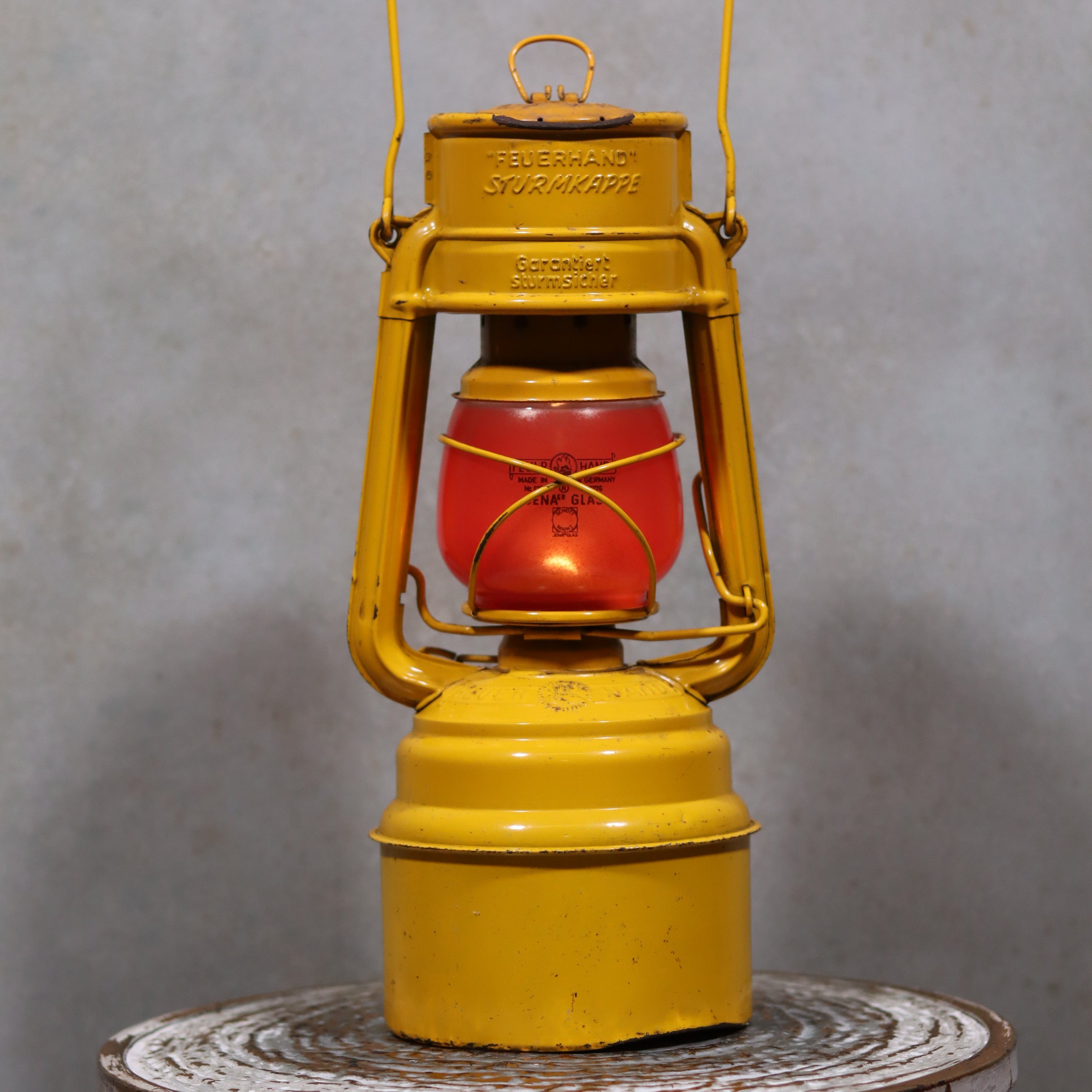 Vintage Feuerhand Hurricane Lantern – Baby Special 276 STK/70 showcasing classic oil lamp design with bright yellow and red German craftsmanship