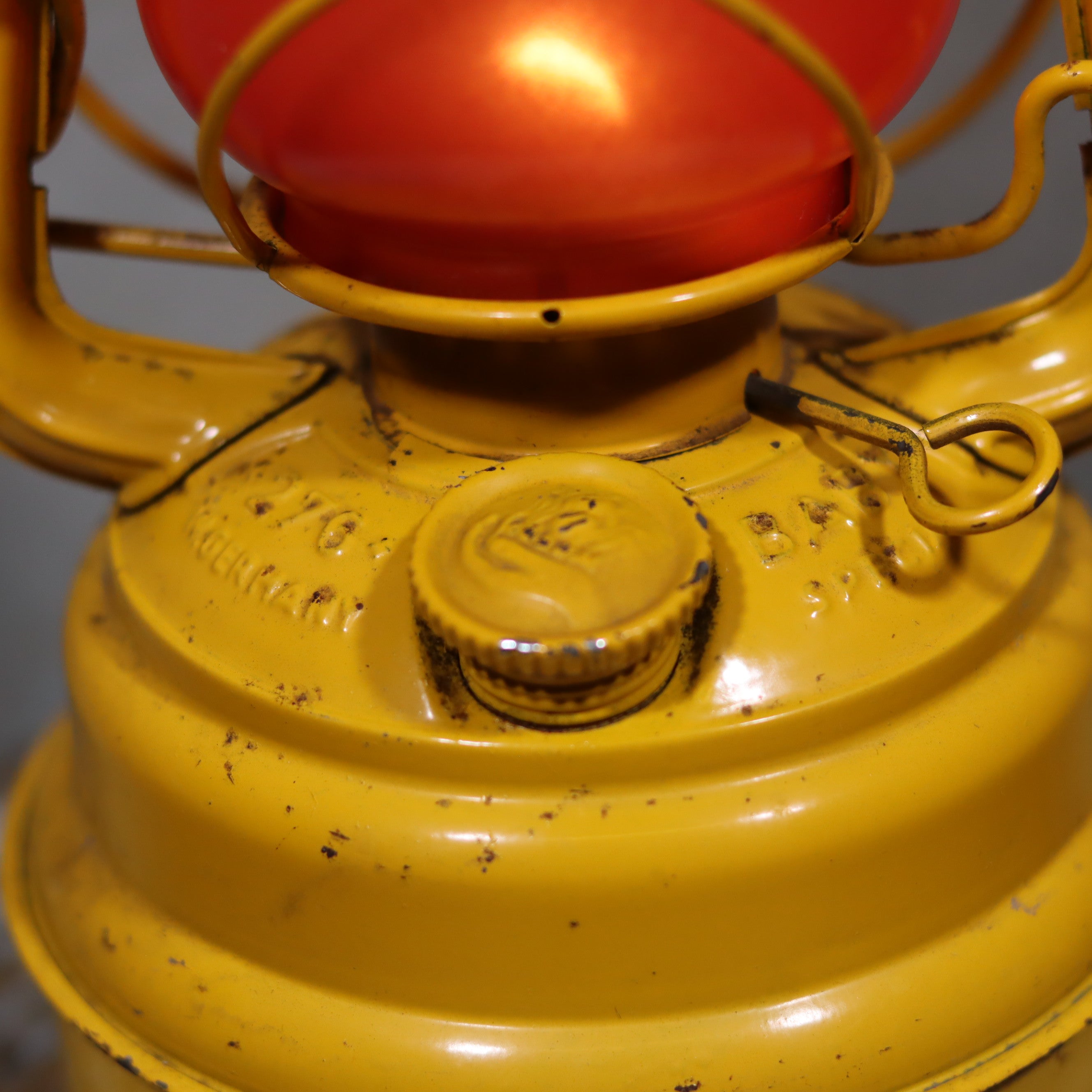 Vintage Feuerhand Hurricane Lantern – Baby Special 276 STK/70 showing close-up detail of yellow oil lamp and brand engraving