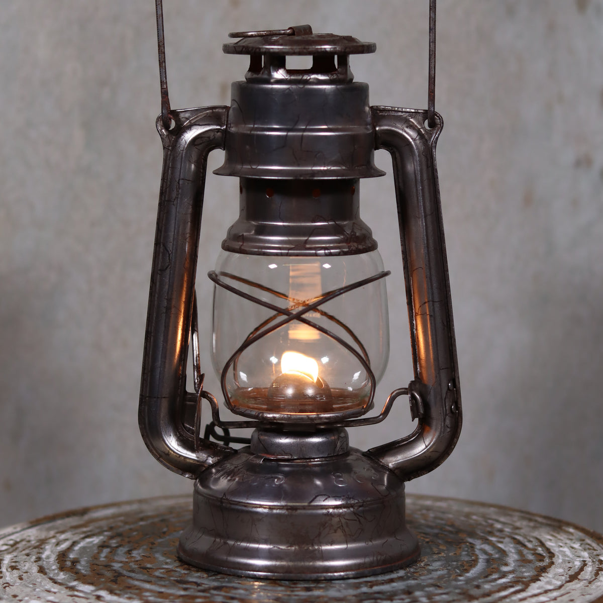 Vintage Czech Storm Lantern – Meva 863 – Made in Czechoslovakia – 1971 – Original Glass oil lamp lit on metal surface