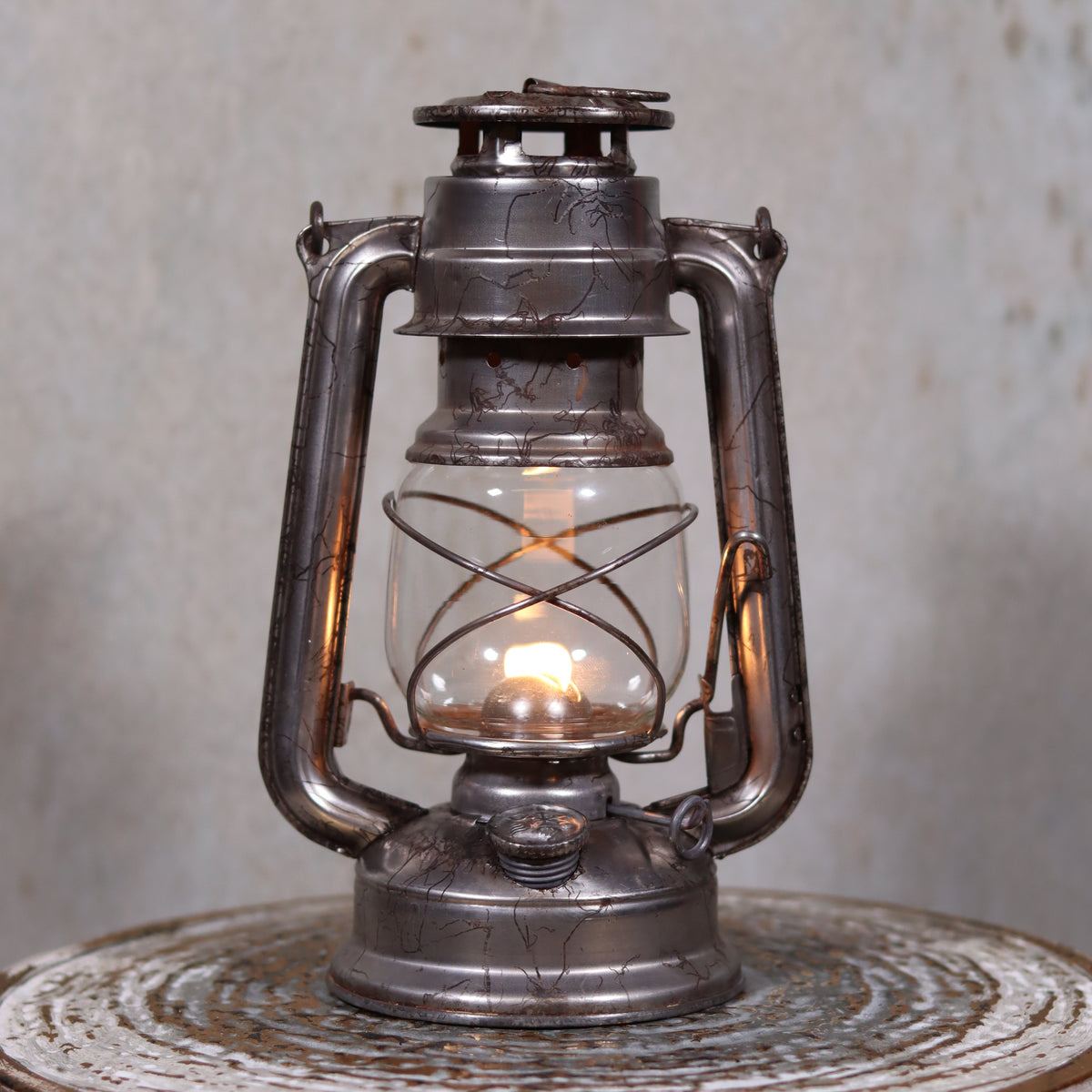Vintage Czech Storm Lantern – Meva 863 – Made in Czechoslovakia – 1971 – Original Glass oil lamp lit on rustic surface