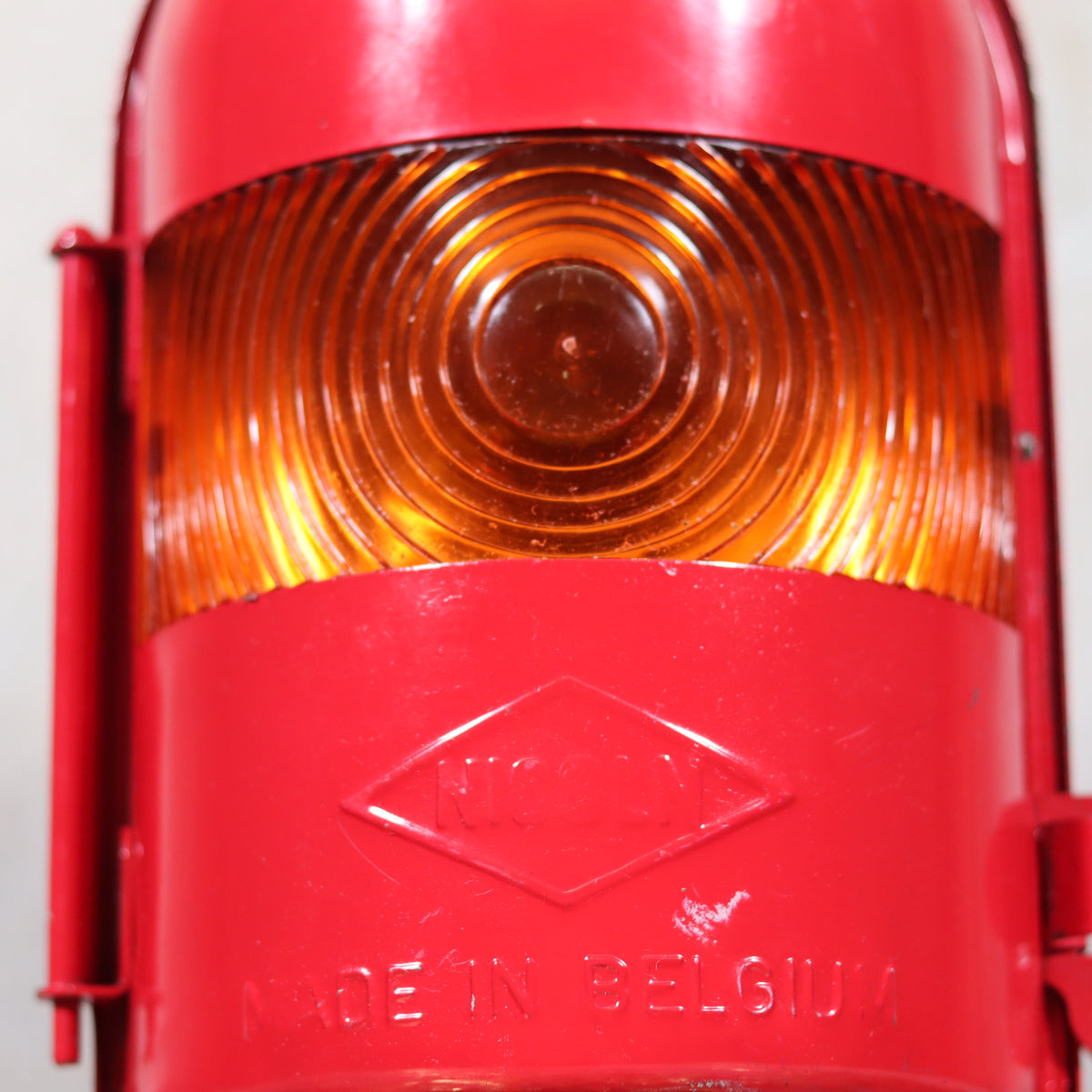 NOS Vintage Nicoln Flashing Oil Lamp – Road Worker Lantern with Original Manual made in Belgium close-up on amber lens and red body