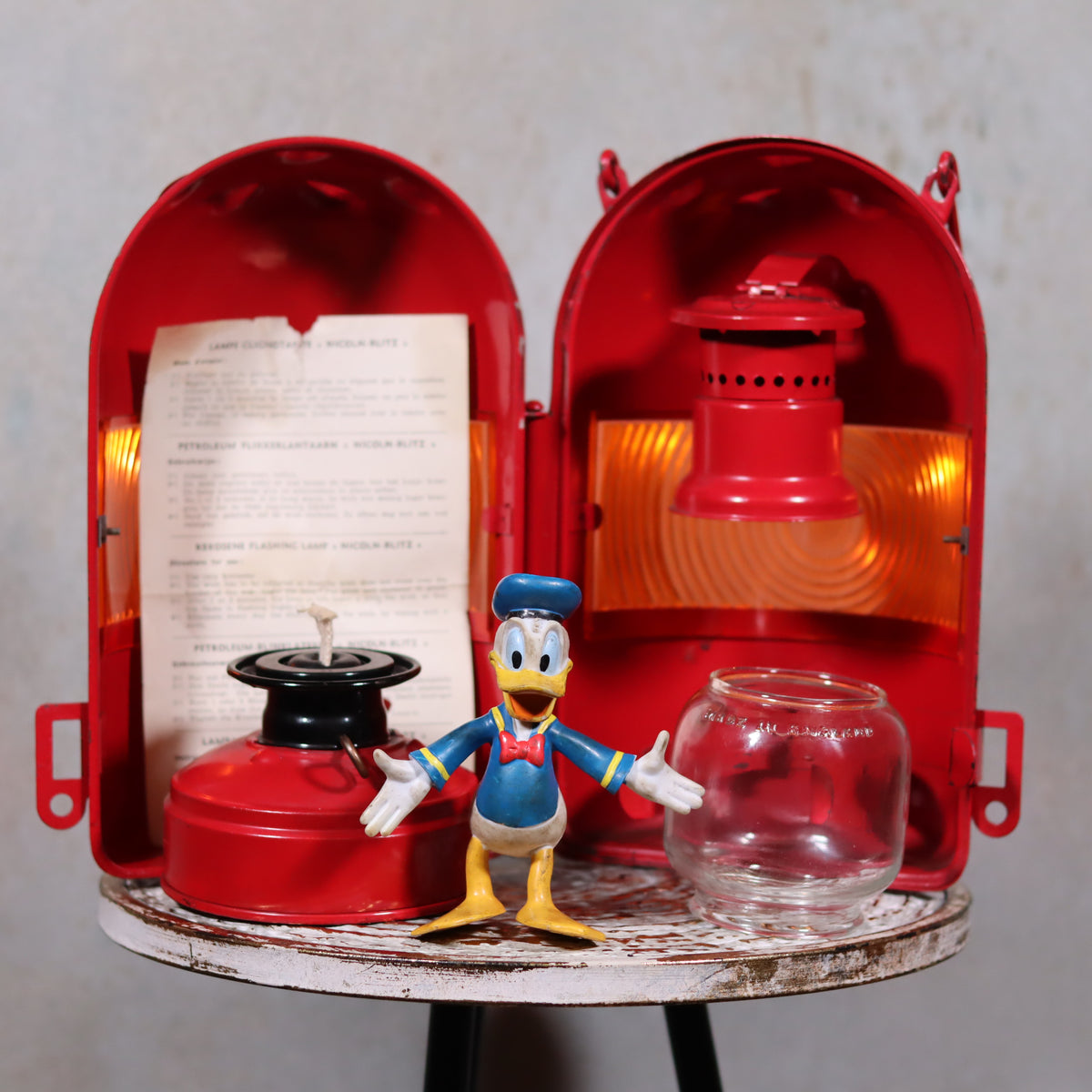 NOS Vintage Nicoln Flashing Oil Lamp – Road Worker Lantern with Original Manual displayed open with parts and Donald Duck figure