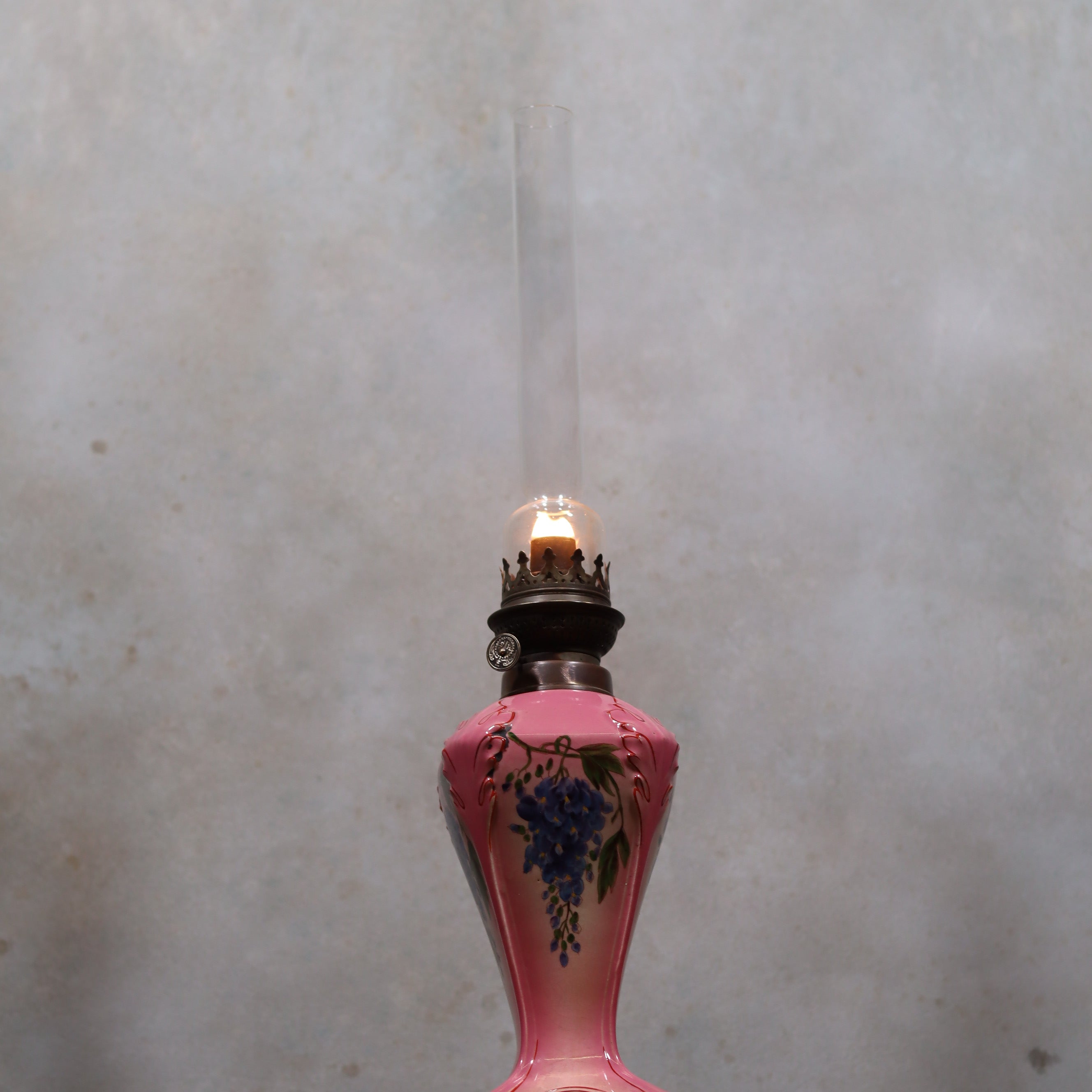 Elegant Vintage Porcelain Oil Lamp – Pink with Grape Motif – Hugo Schneider Burner – 1930s lit against neutral background