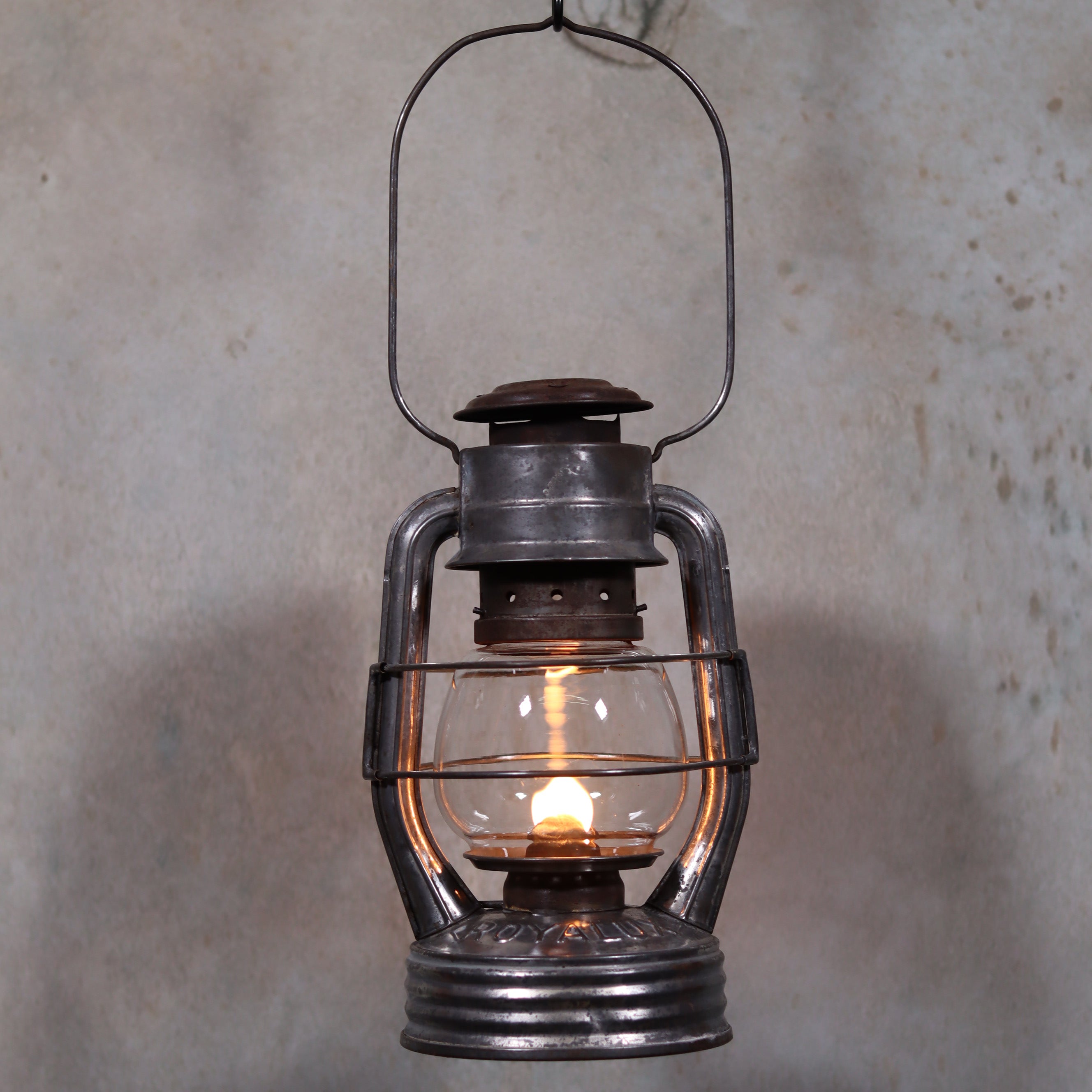 Vintage French Royalux Hurricane Lantern – Rare Glass Lift & Cage (27 cm) glowing oil lamp with metal frame and handle