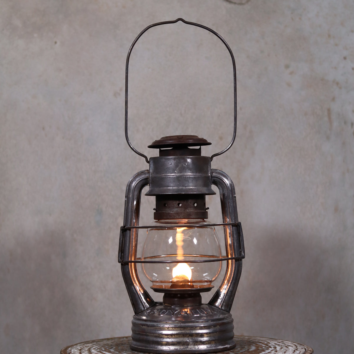 Vintage French Royalux Hurricane Lantern – Rare Glass Lift & Cage (27 cm) oil lamp glowing in dim setting