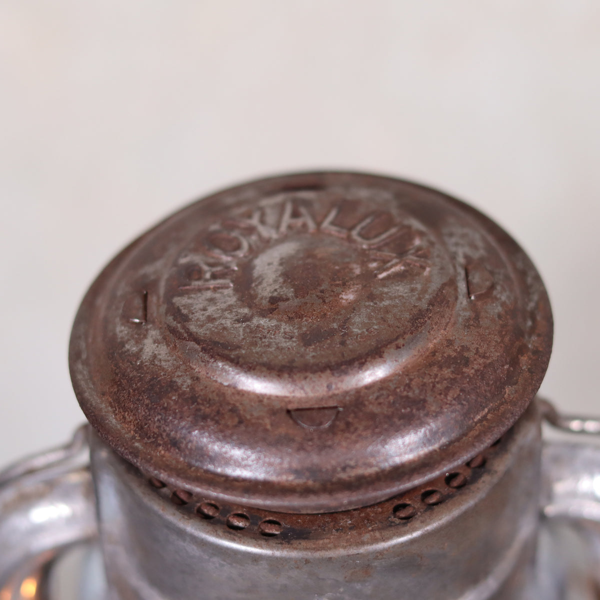 Close-up of rusted top part of Vintage French Royalux Hurricane Lantern – Rare Glass Lift & Cage (27 cm) oil lamp showing embossed Royalux logo