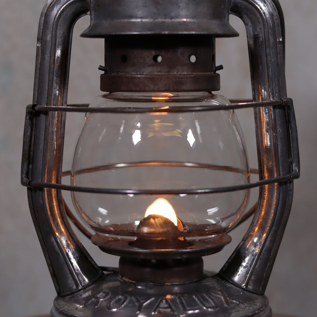 Vintage French Royalux Hurricane Lantern – Rare Glass Lift & Cage (27 cm) oil lamp with glowing flame and metal cage design