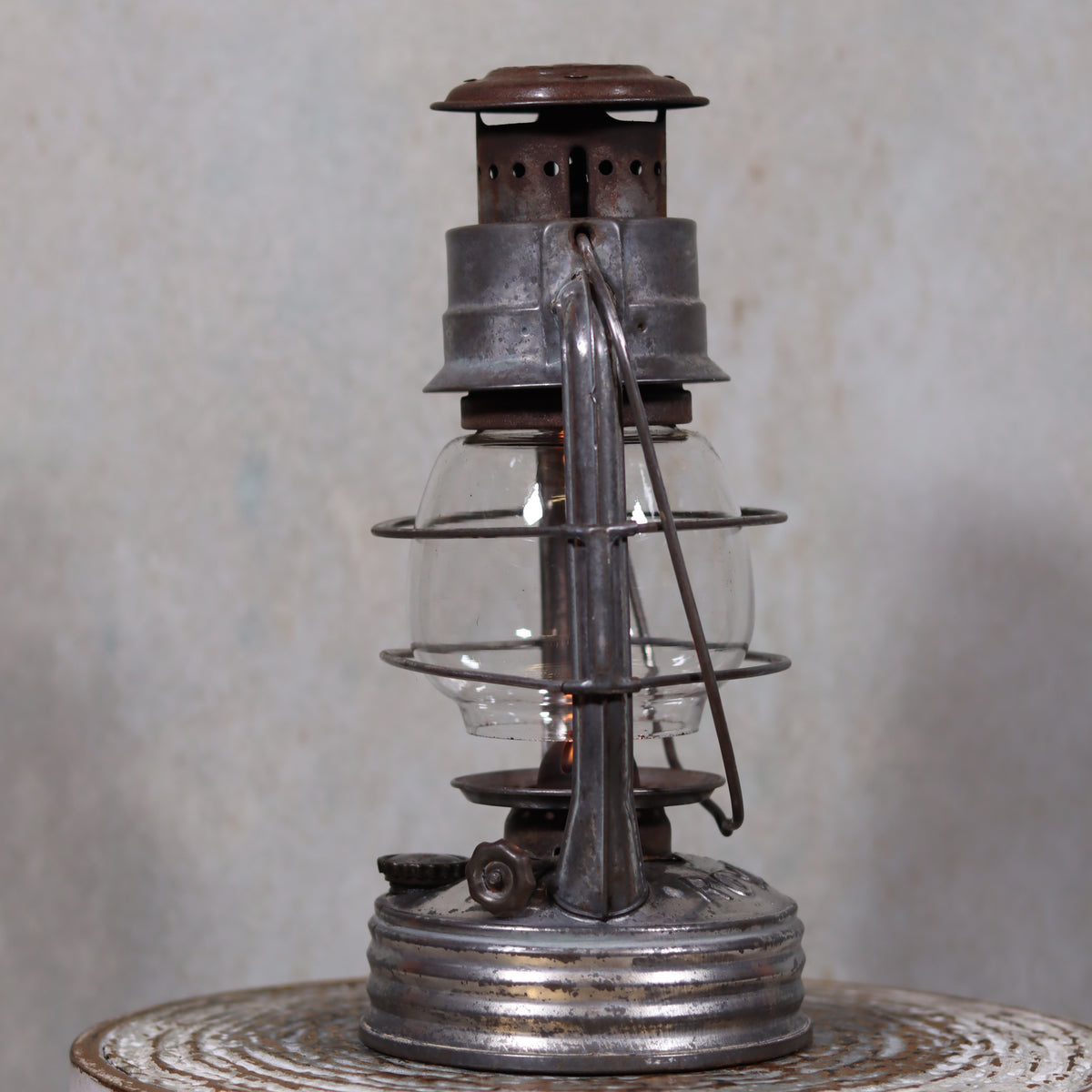 Vintage French Royalux Hurricane Lantern – Rare Glass Lift & Cage oil lamp with metal frame and rustic patina, 27 cm tall.