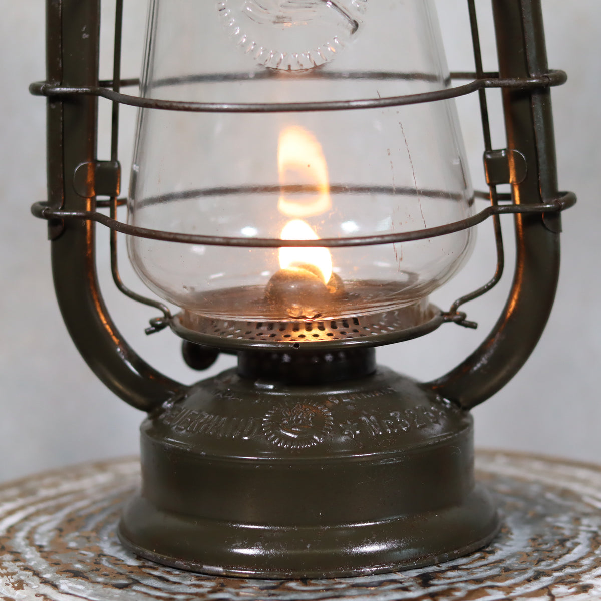 Vintage Feuerhand 323 Storm Lantern – Late 1930s with original paint and embossed glass showing the oil lamp flame