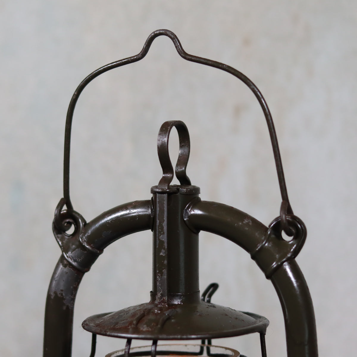 Vintage Feuerhand 323 Storm Lantern – Late 1930s, Original Paint & Embossed Glass oil lamp handle and top detail close-up view