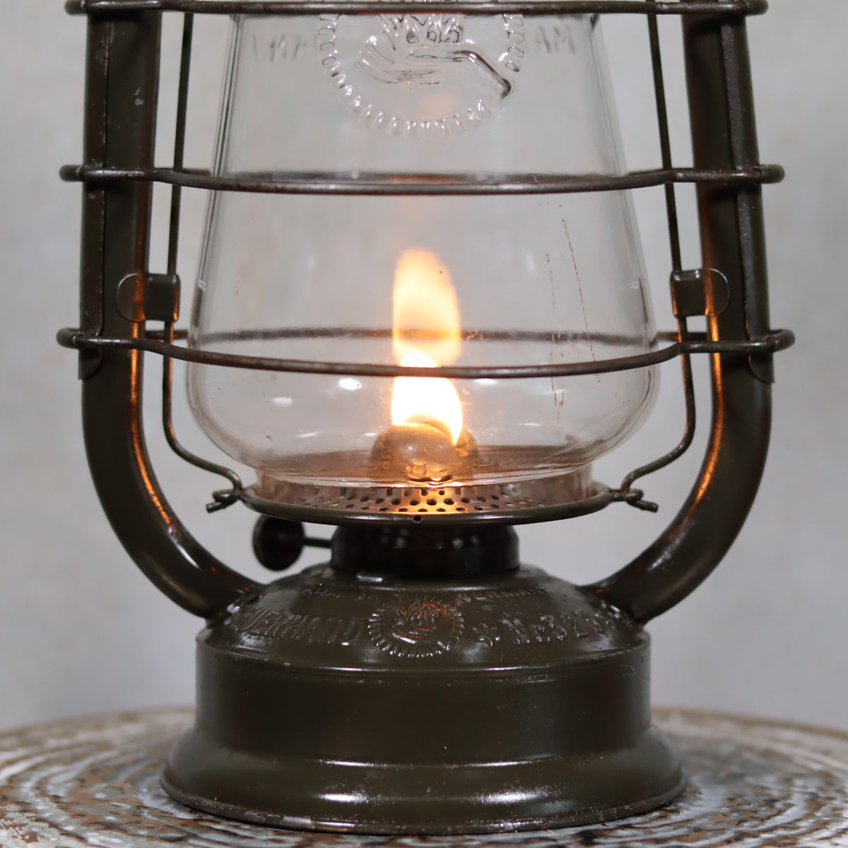 Vintage Feuerhand 323 Storm Lantern – Late 1930s, Original Paint & Embossed Glass with a burning oil lamp flame