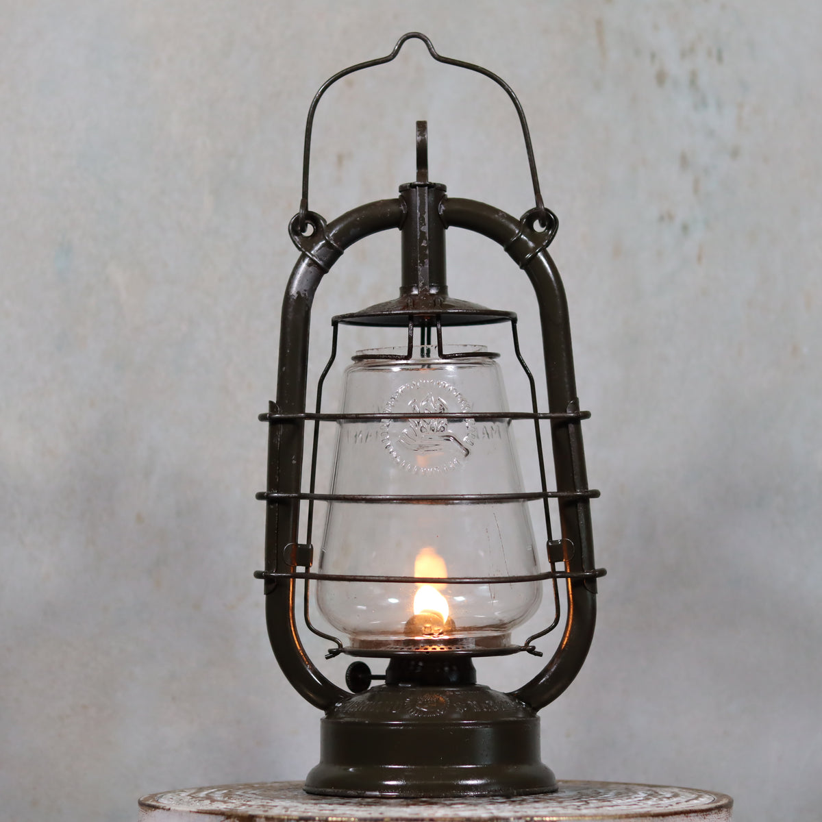 Vintage Feuerhand 323 Storm Lantern – Late 1930s, Original Paint & Embossed Glass oil lamp with flame inside and metal frame