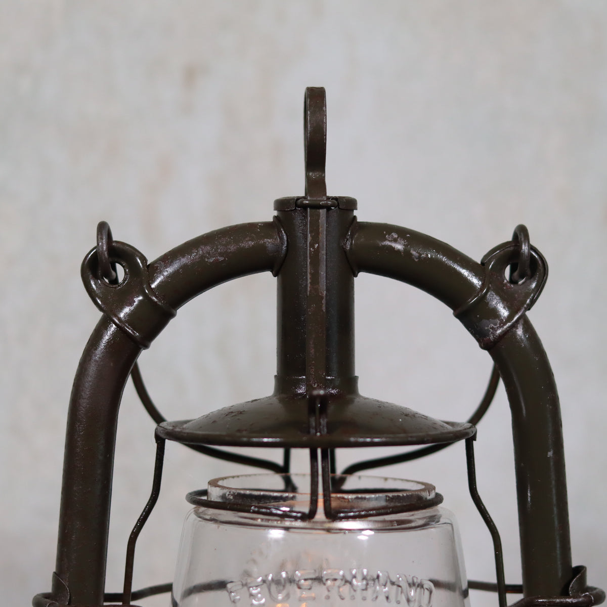 Vintage Feuerhand 323 Storm Lantern – Late 1930s, Original Paint & Embossed Glass oil lamp detail focused on metal frame and handle