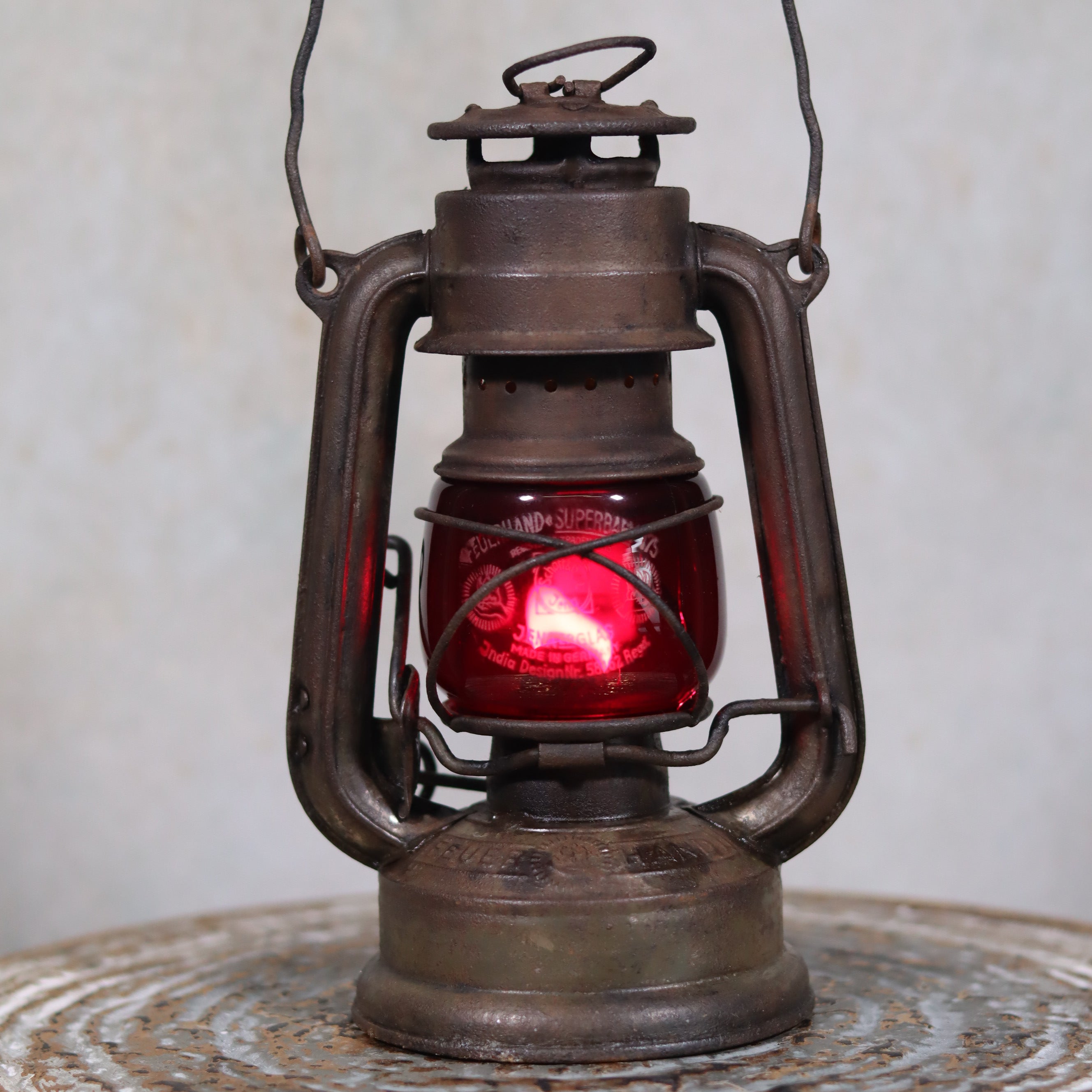 Vintage Pre-War Storm Lantern – Feuerhand 175 (1930s) with Red Glass oil lamp with rustic metal frame and red glass panel.