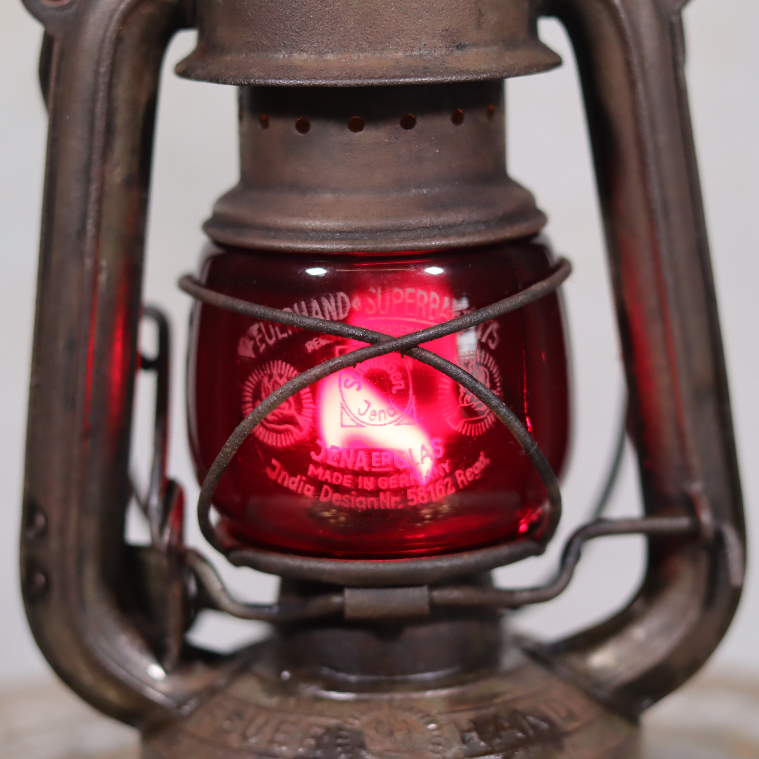 Close-up of Vintage Pre-War Storm Lantern – Feuerhand 175 (1930s) with Red Glass oil lamp detail and metal frame