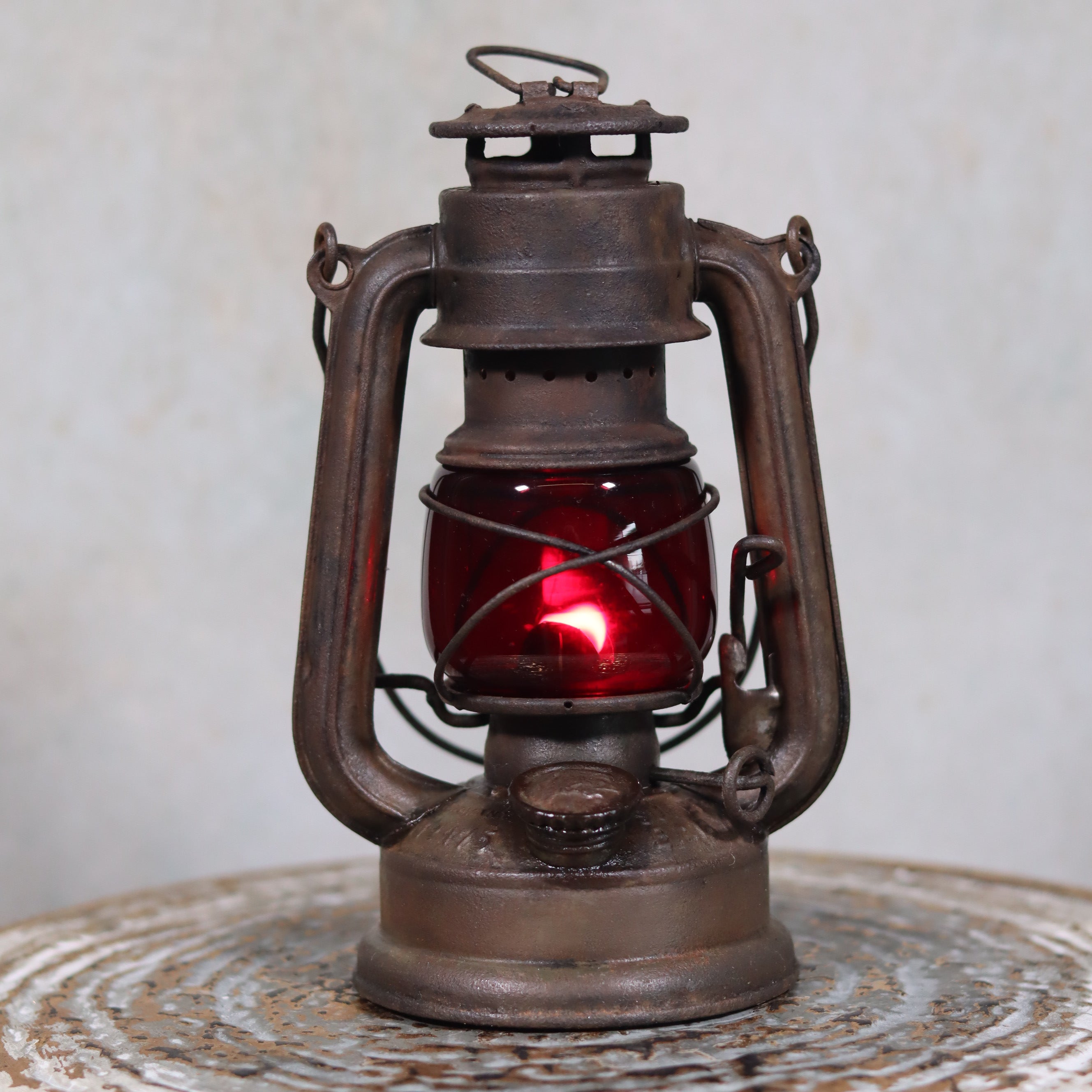 Vintage Pre-War Storm Lantern – Feuerhand 175 (1930s) with Red Glass showing detailed antique oil lamp design