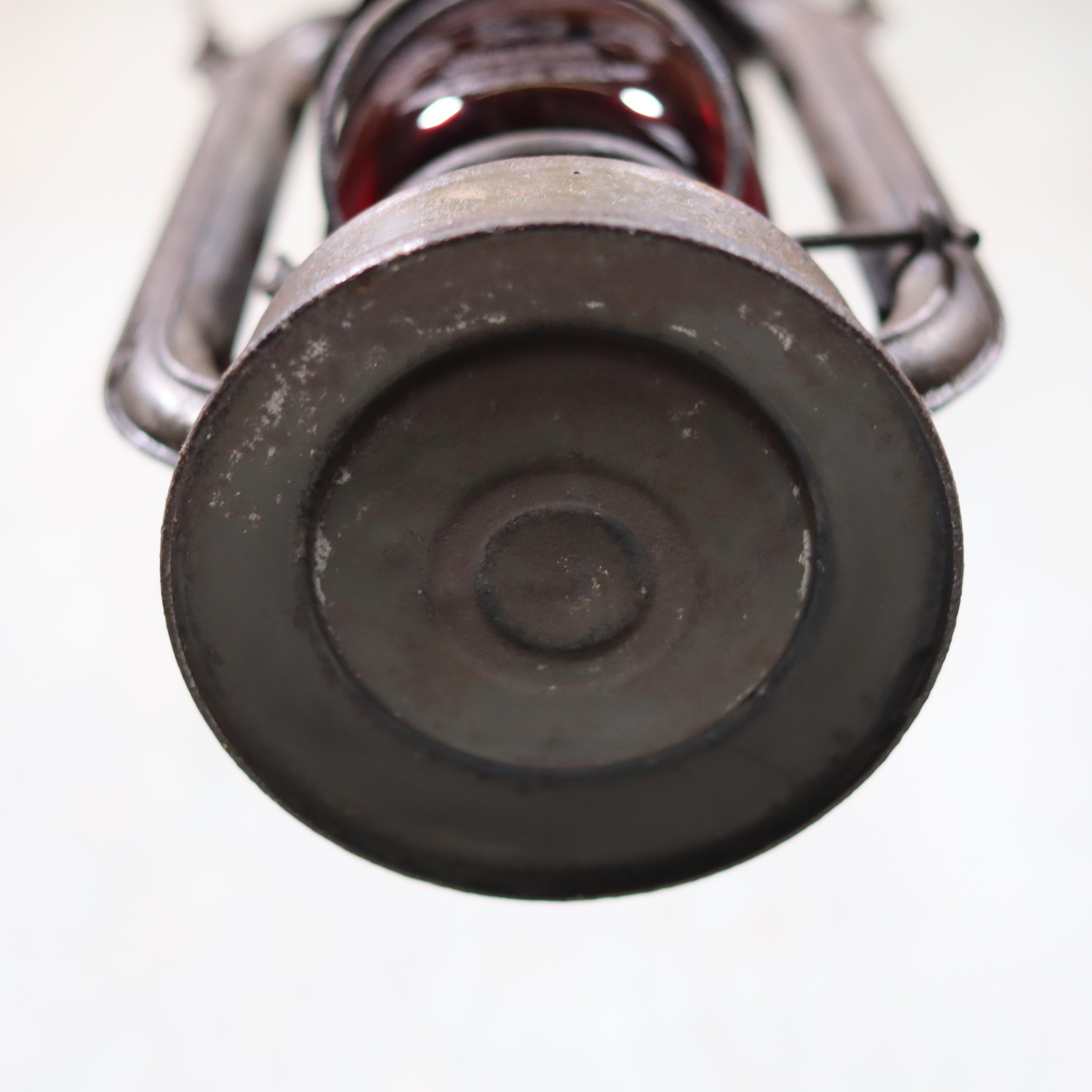 Vintage Pre-War Storm Lantern – Feuerhand 175 (1930s) with Red Glass showing the metal base of the oil lamp