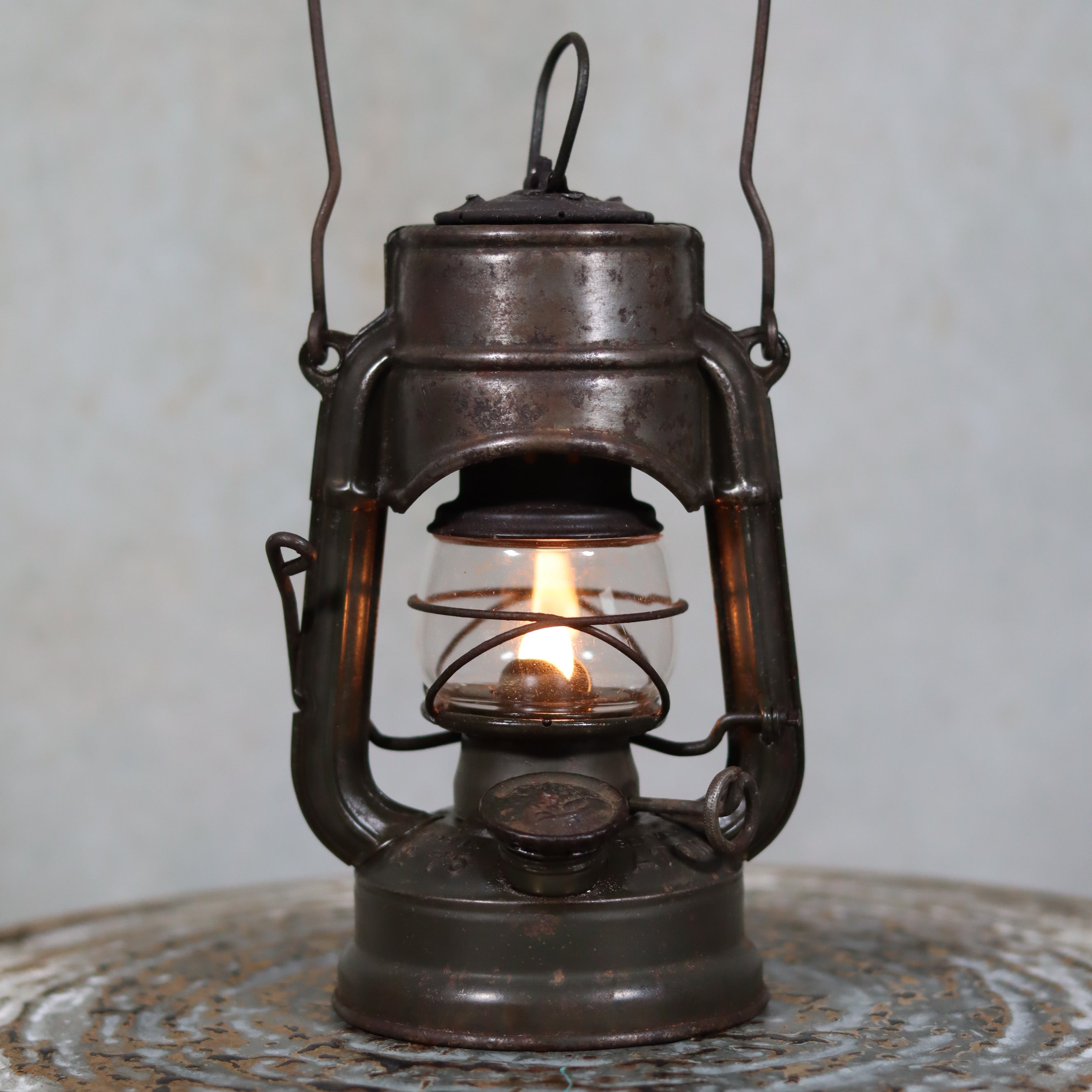 Beautiful and Functional Feuerhand “Atom 75 STK” Storm Lantern – Pre-War, Late 1930s to Early 1940s oil lamp lit and displayed close-up